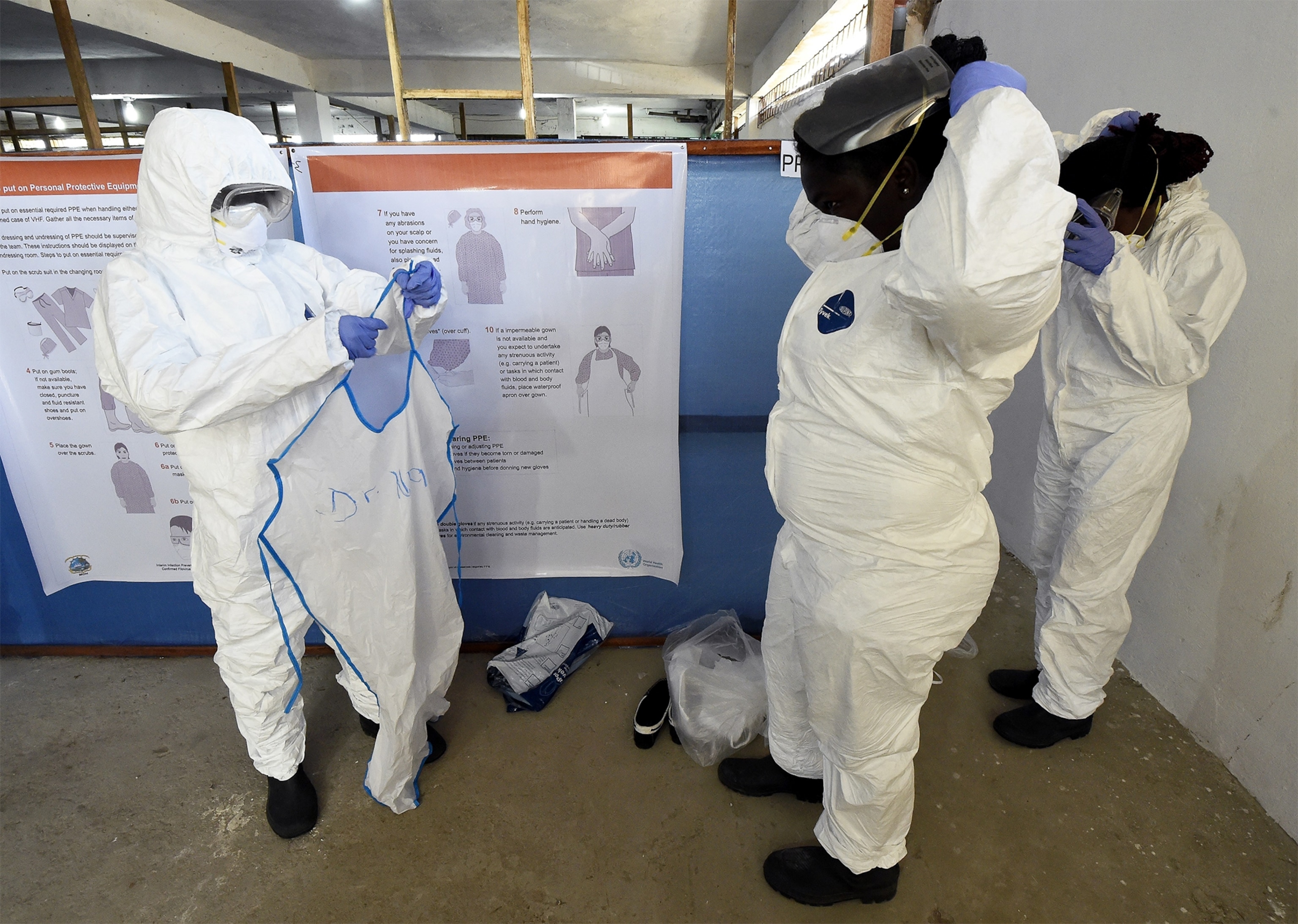health workers putting on their protective clothing before visiting Ebola patients in Liberia.