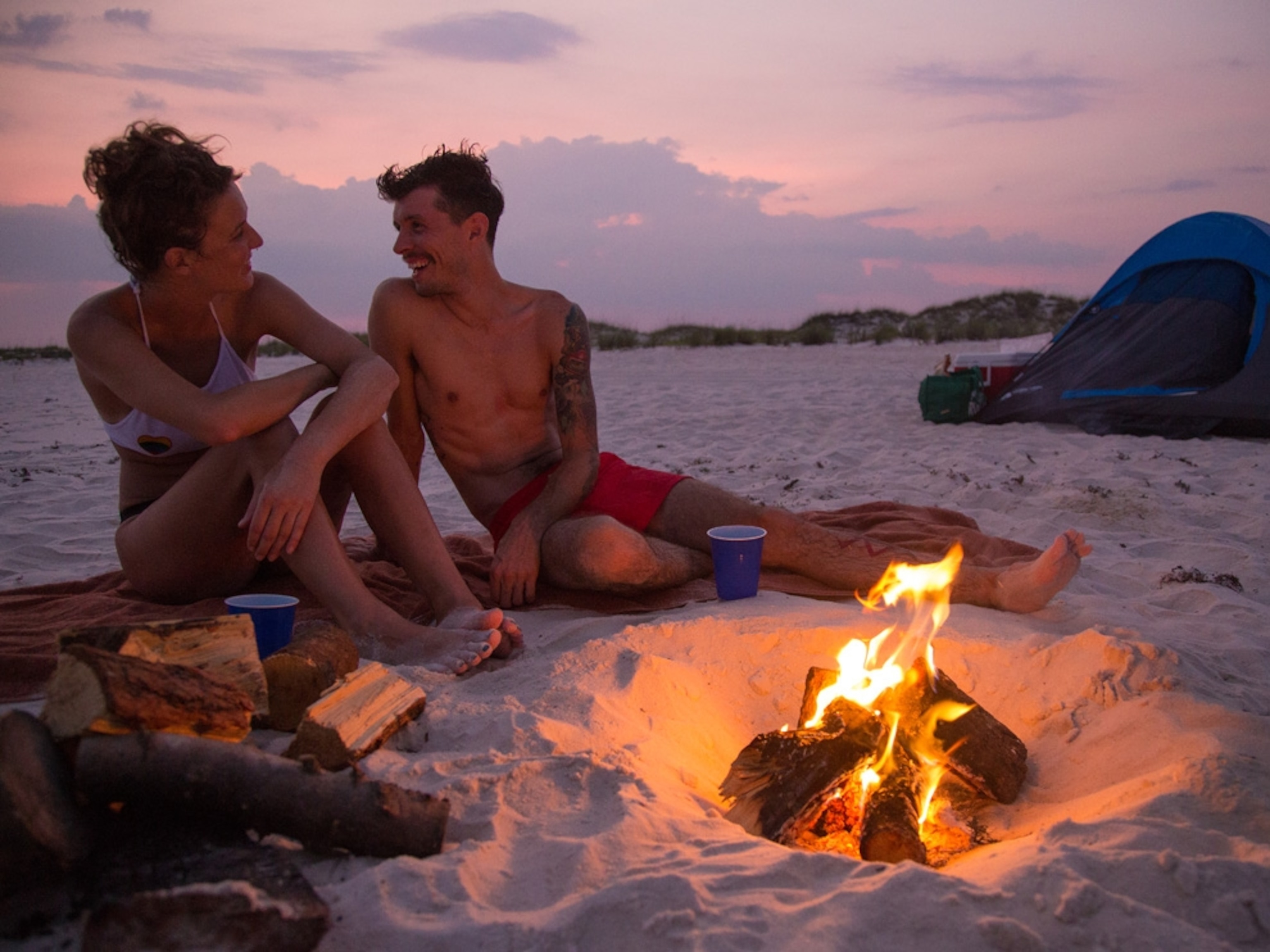 a couple sitting by a beach campfire on Gulf Islands National Seashore, Florida