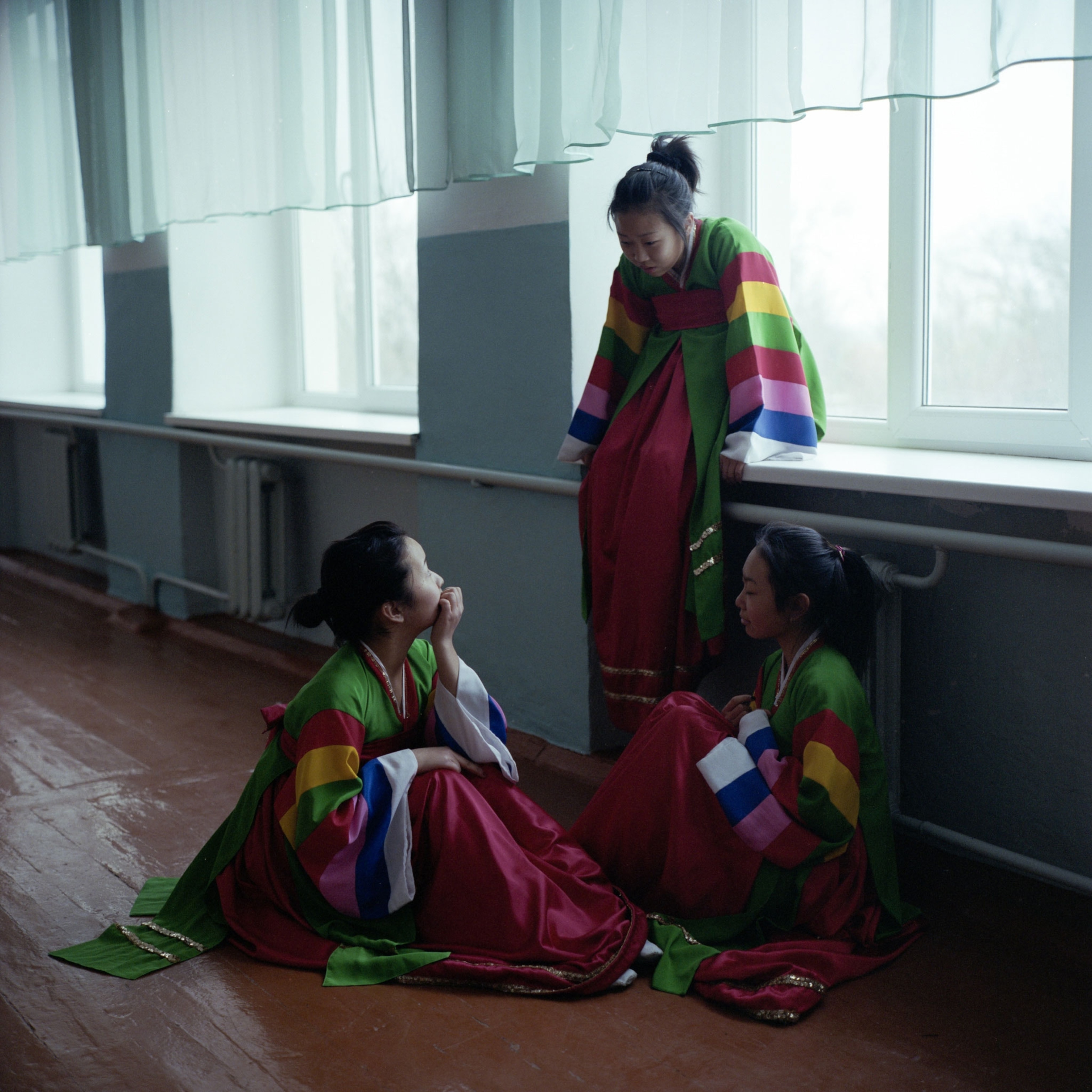 Korean teenagers wear traditional dresses after a rehearsal
