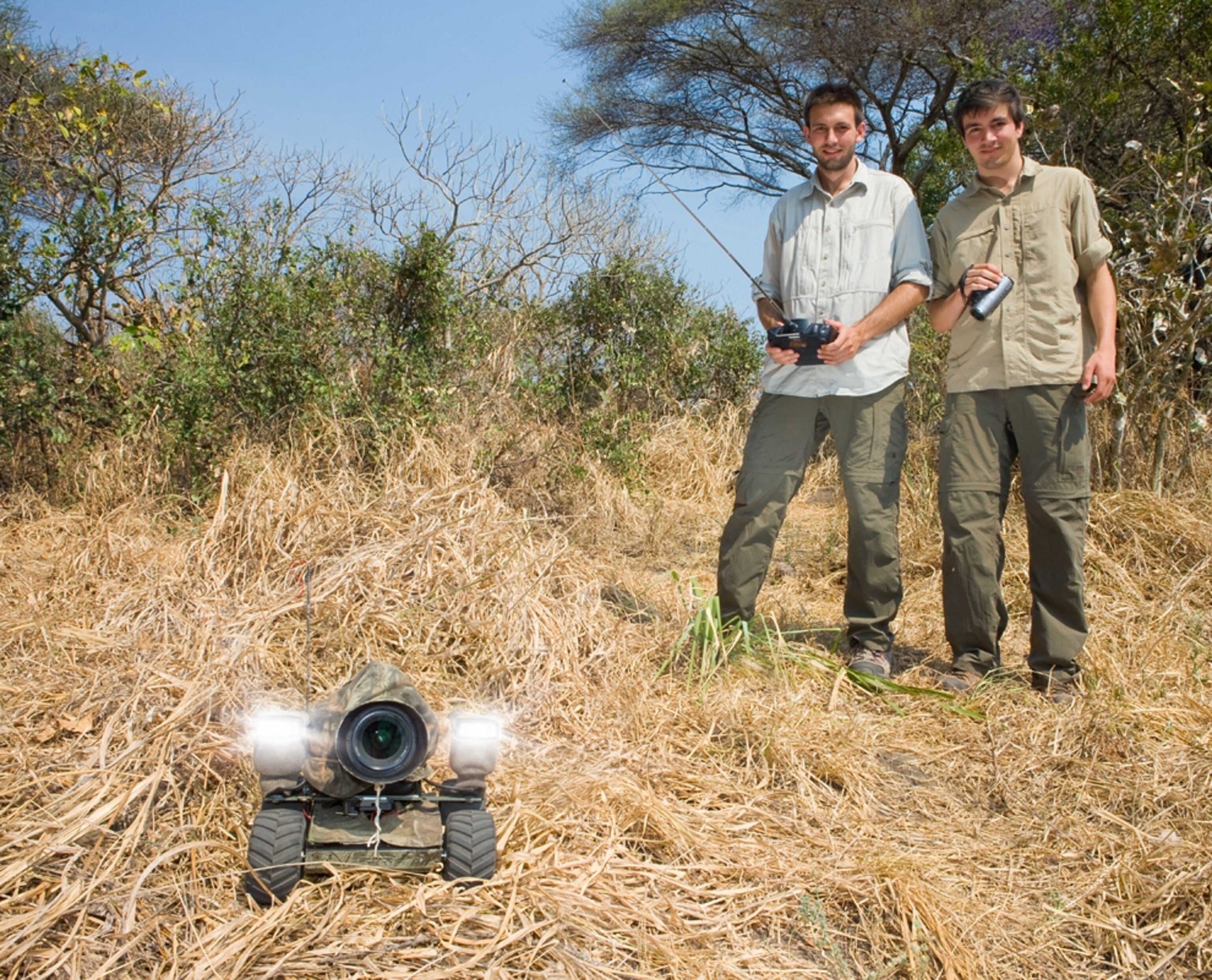 A picture of the creators of BeetleCam with their invention, a remote control camera, which was later mauled by a lion.