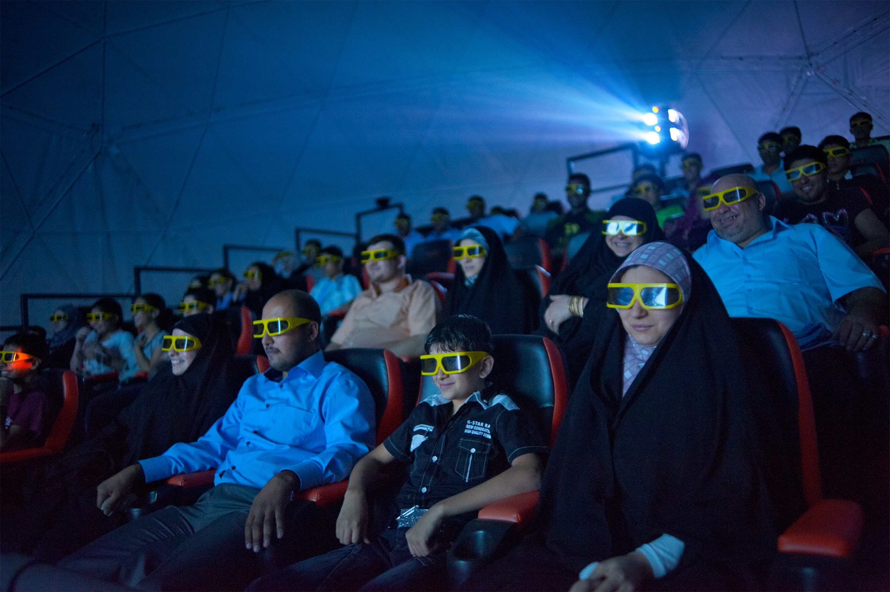 moviegoers watching a movie in 3-D in Iraq