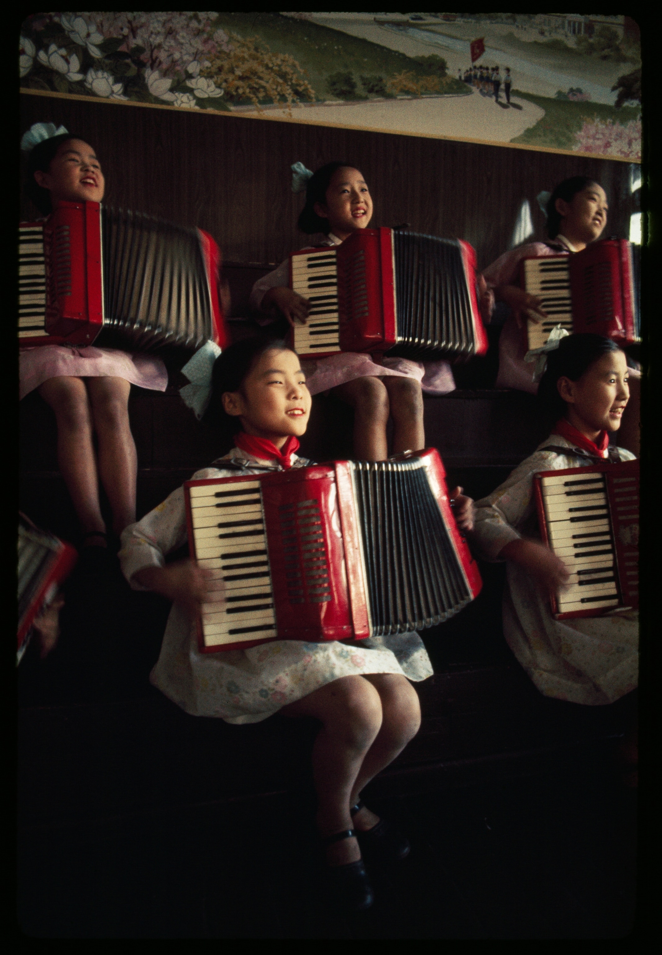 North Korean school girls practice playing accordions.