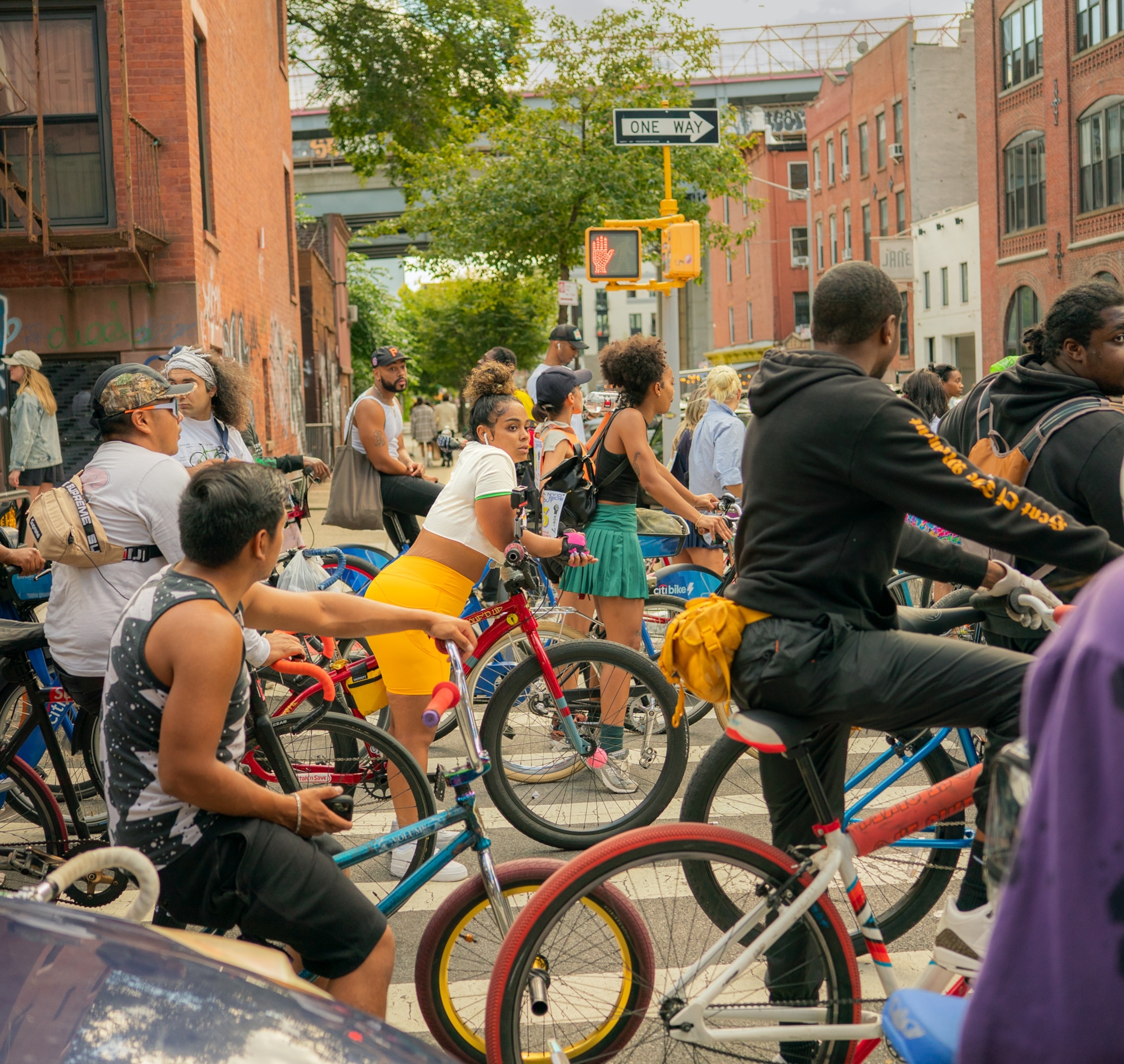 The young woman in red shirts in the middle of the pack of bike riders.