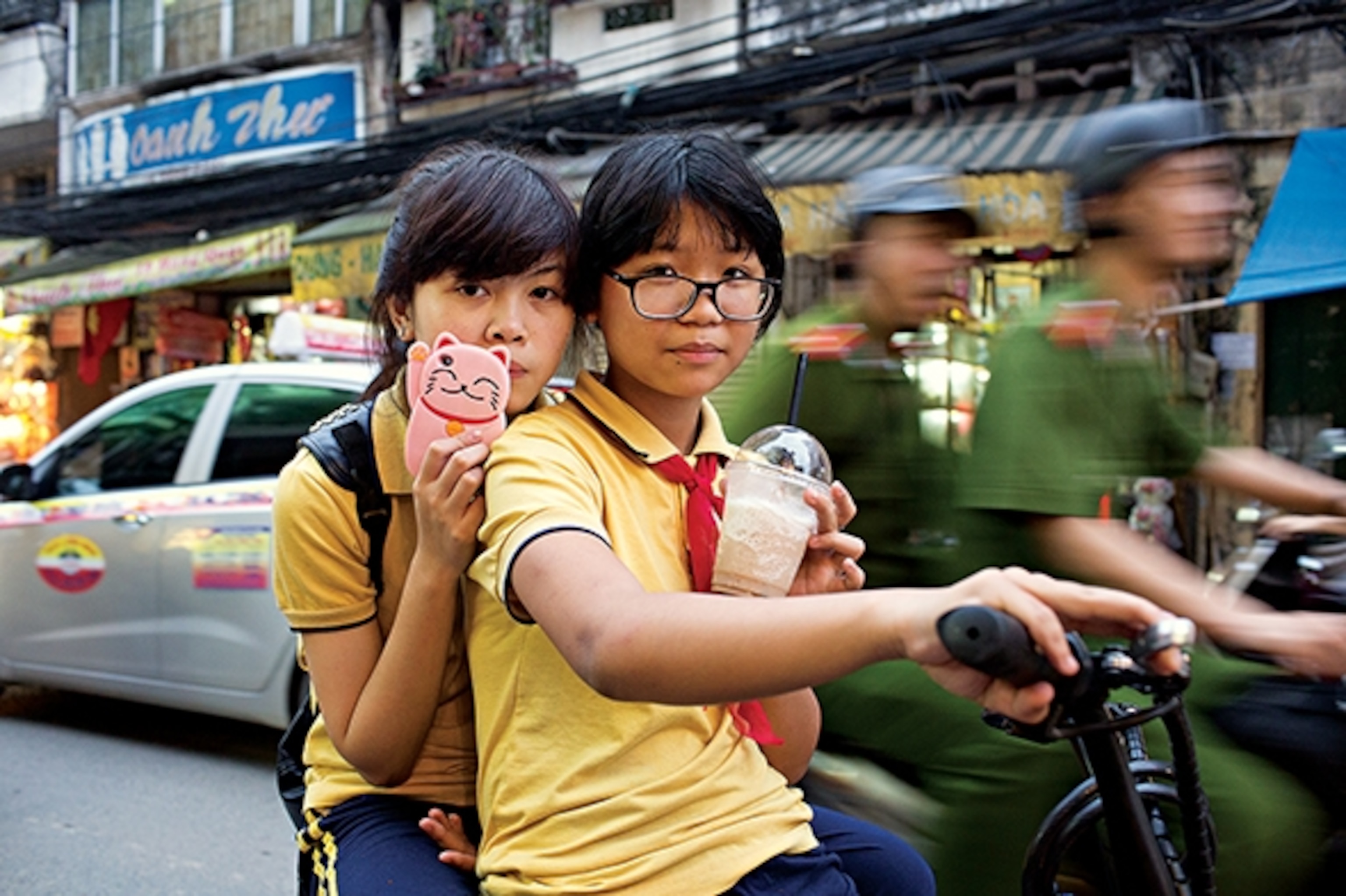 Hanoi schoolgirls get around on a motor scooter. (Photograph by Catherine Karnow)