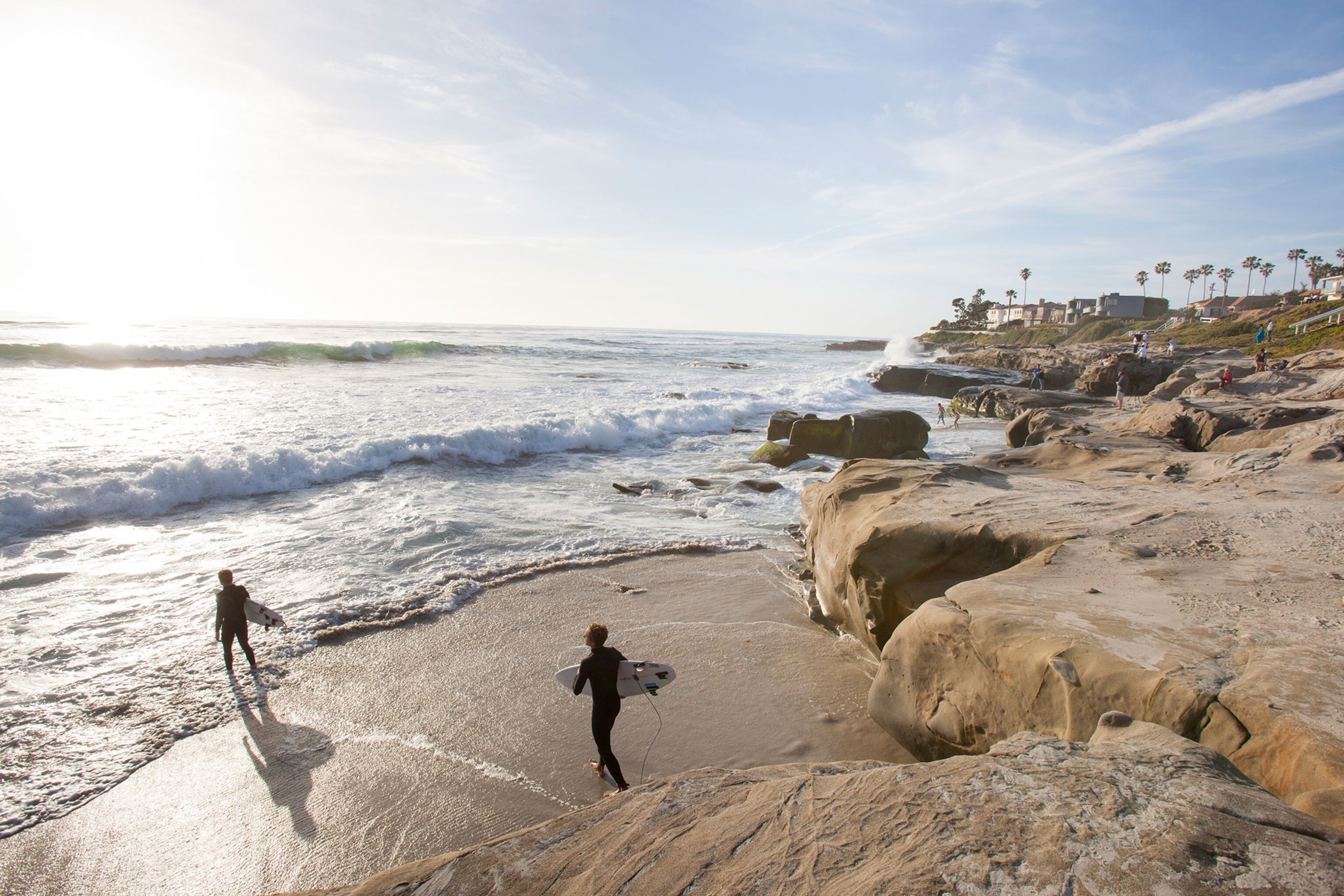 two surfers approaching the sea in San Diego, California