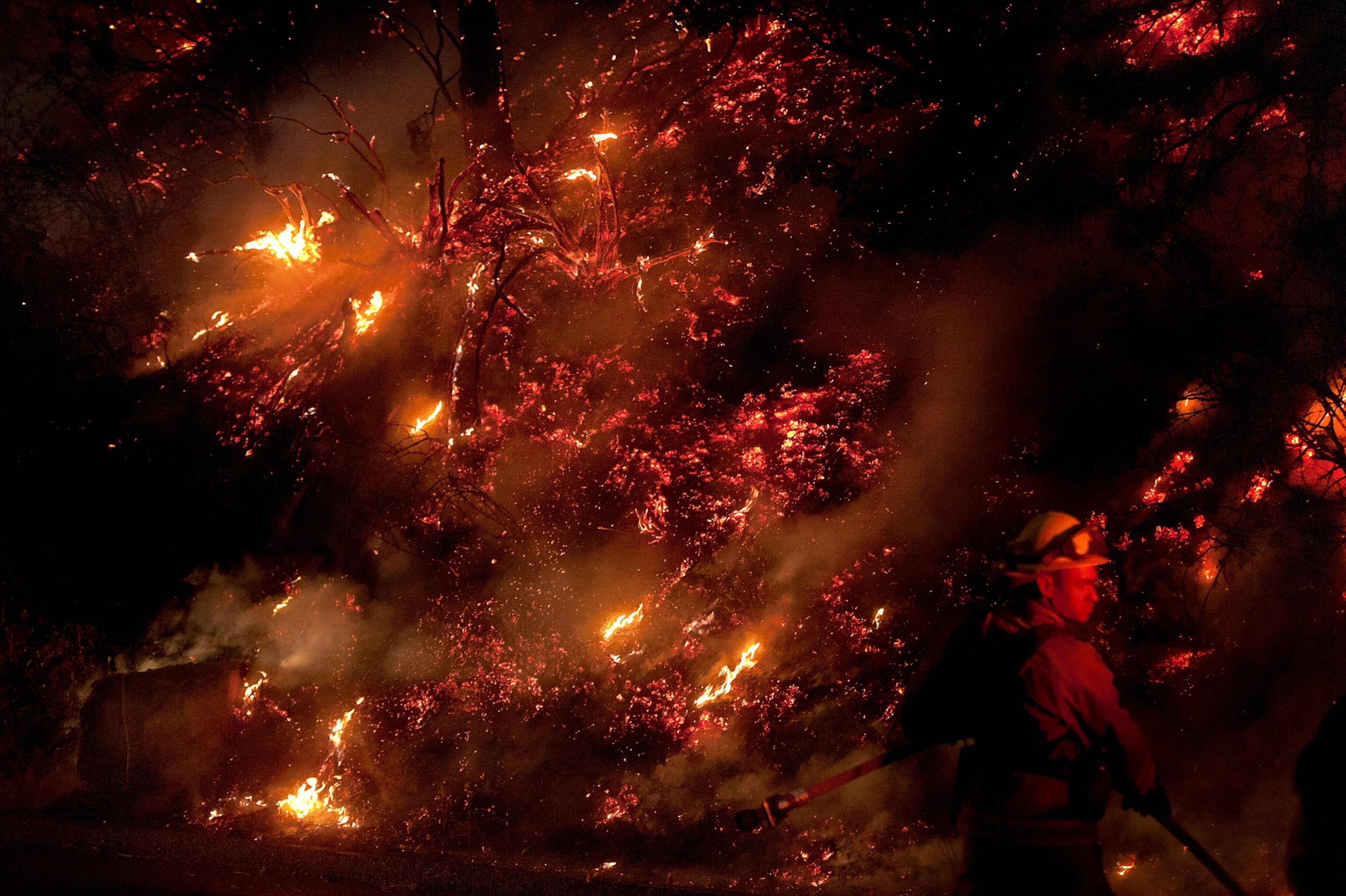 a firefighter battling smoke and ash in the Rim Fire