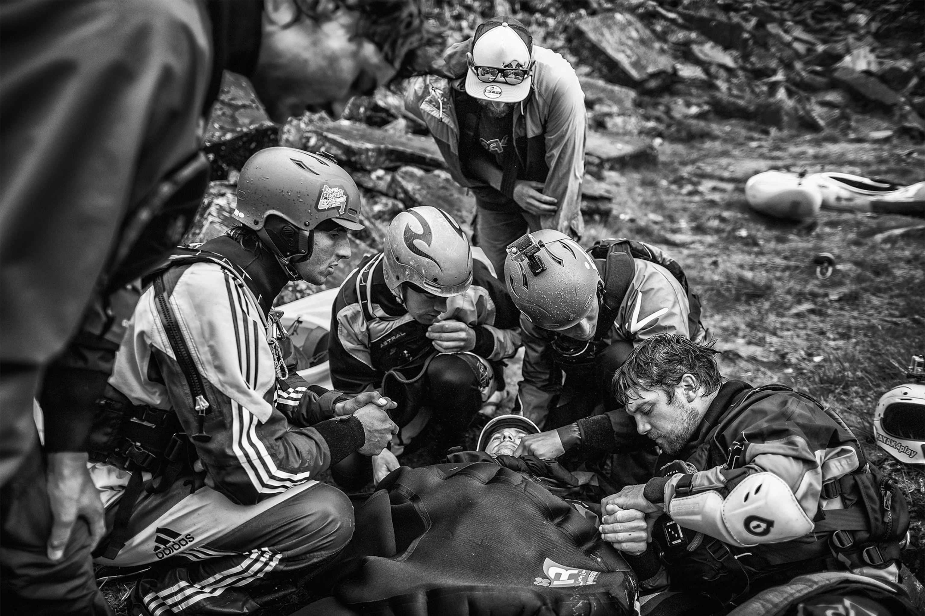 a group of Kayakers tending to an injured friend