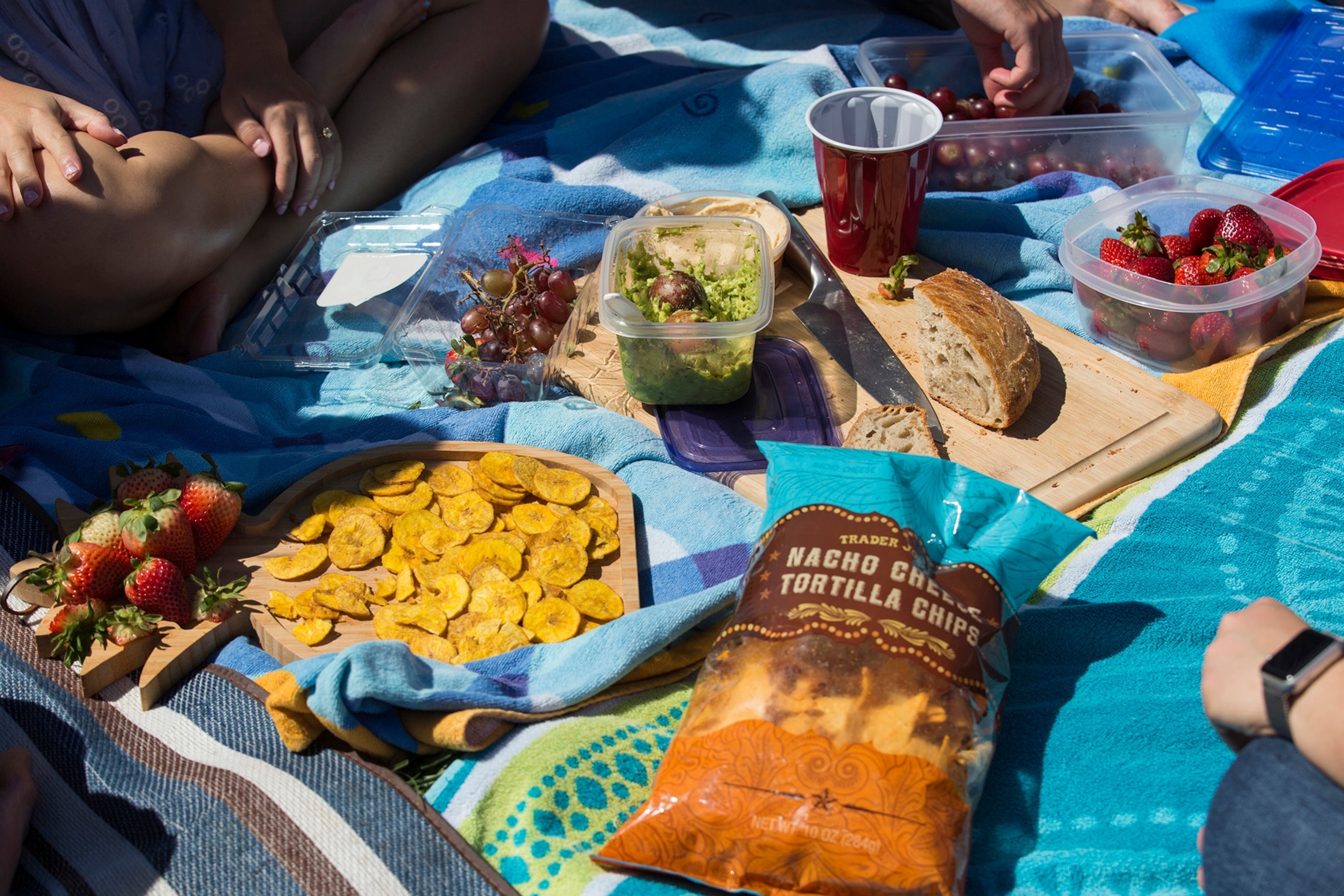 Friends share snacks at the first Presidio Picnic of the year in Presidio Park, in San Francisco, California, March 31, 2019.