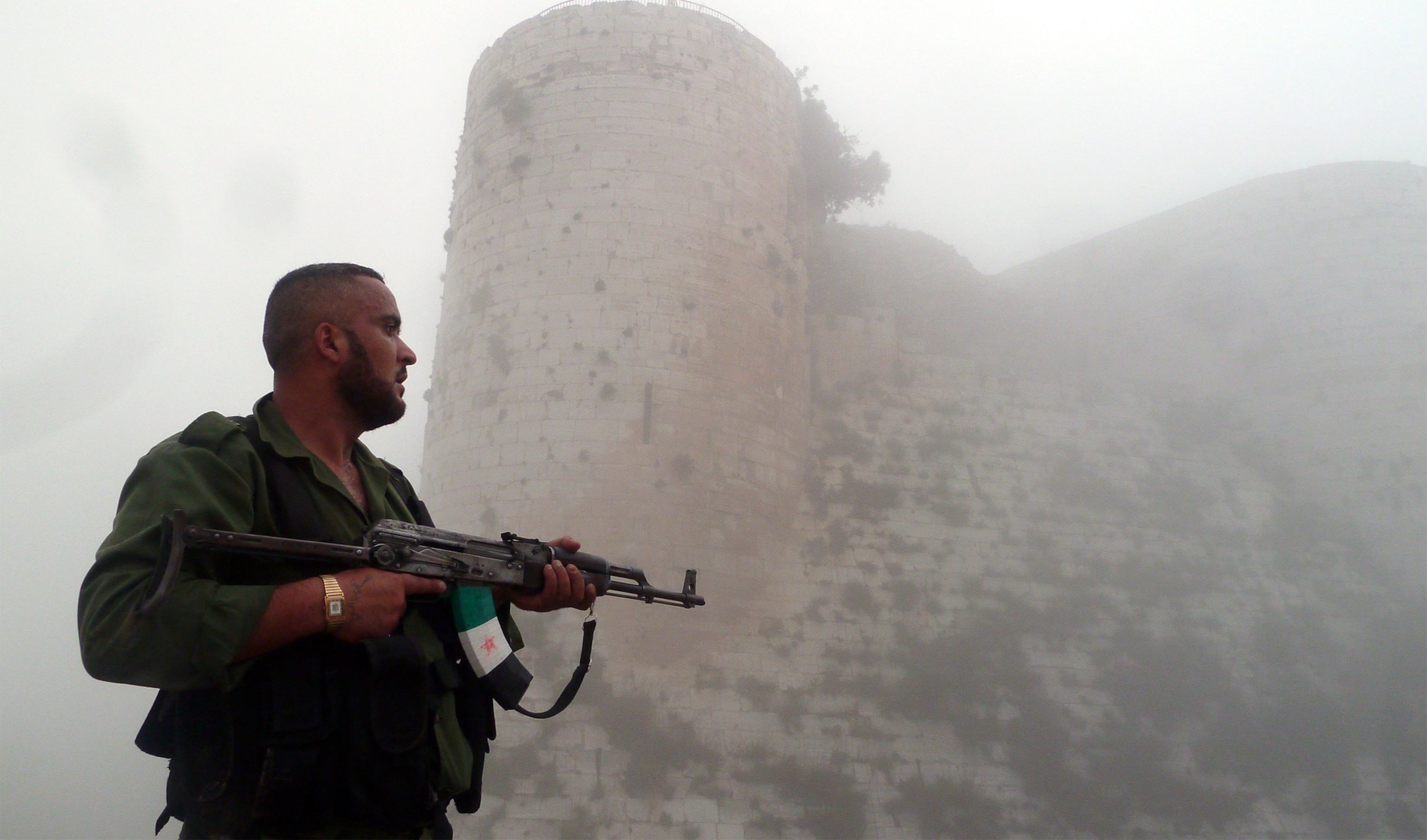 a member of the Free Syrian Army near the 'Al-Hosn' Crusaders Citadel on the outskirts of Homs, Syria