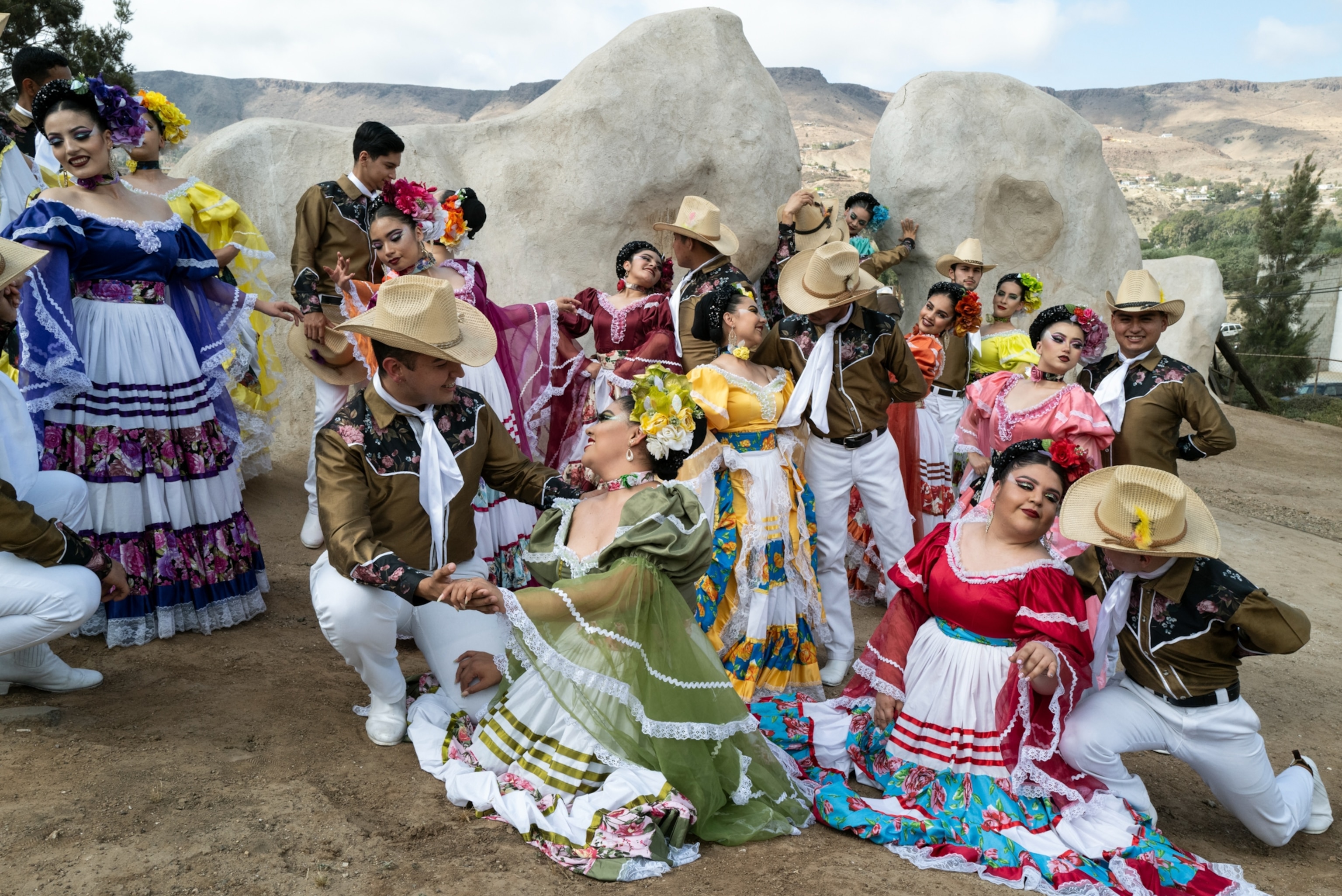 Dancers pose in brightly colored traditional garments