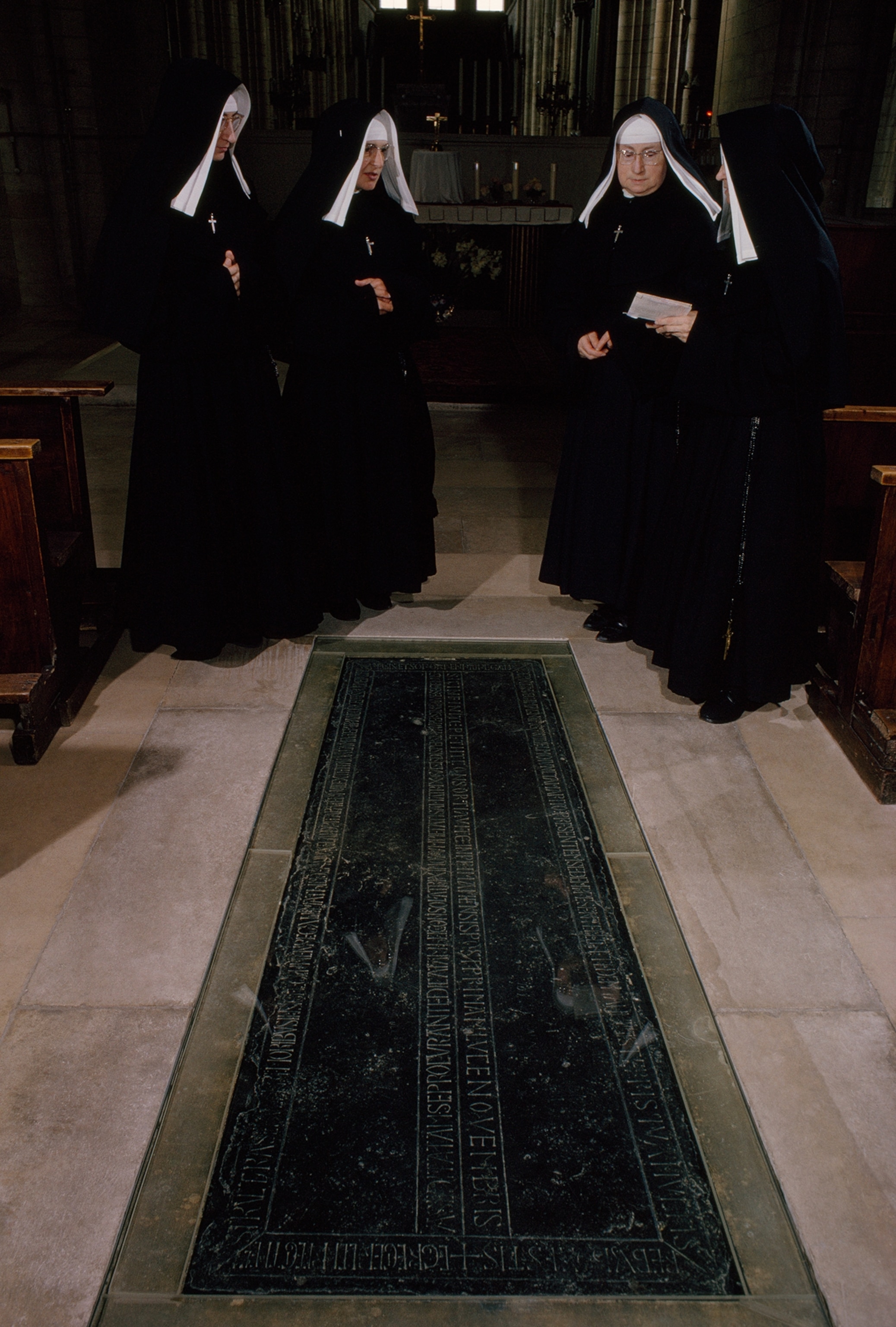 Nuns stand at marble slab for Matilda, wife of William the Conqueror.