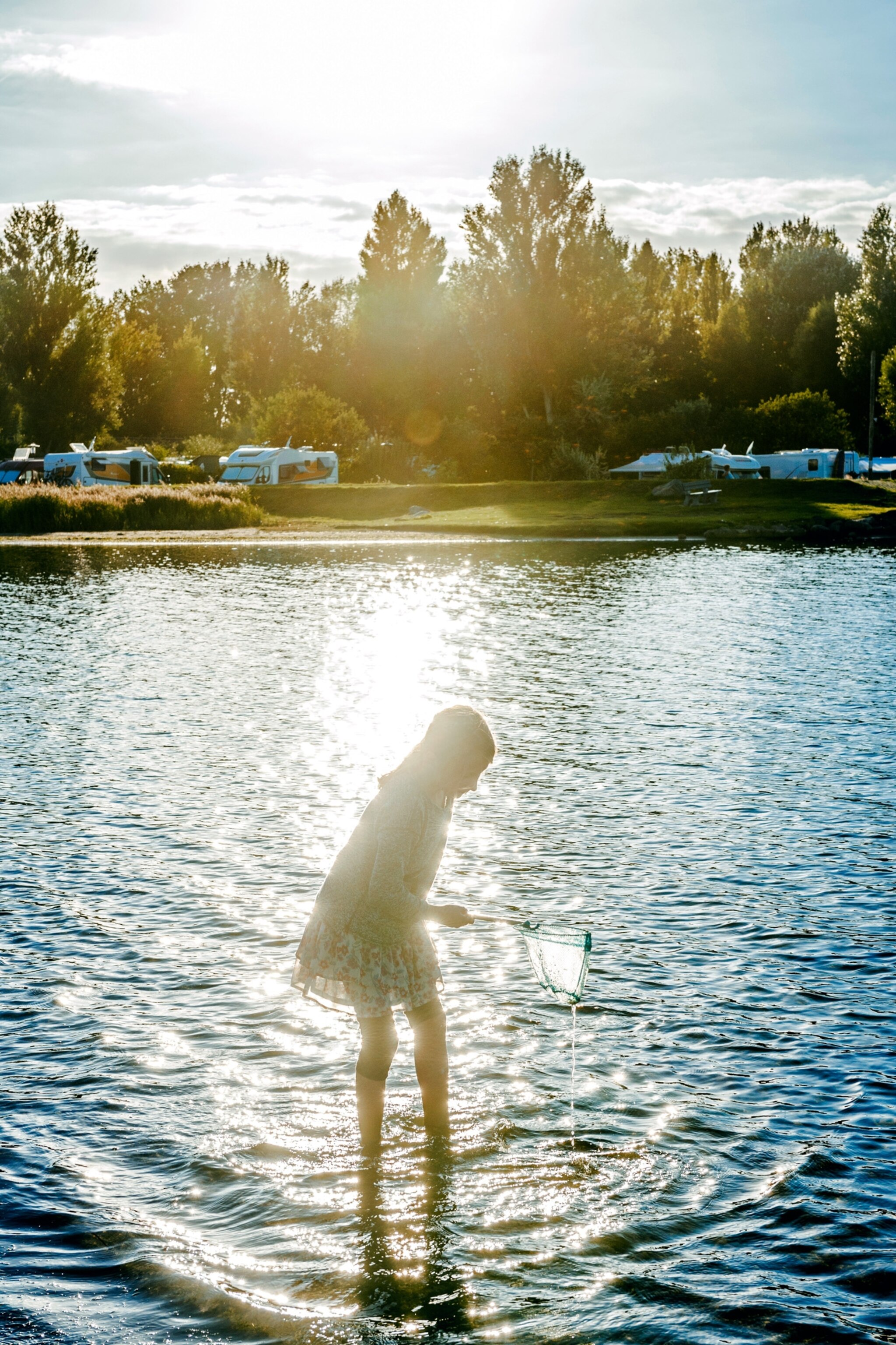 A young girl enjoys camping in Fehmarn.