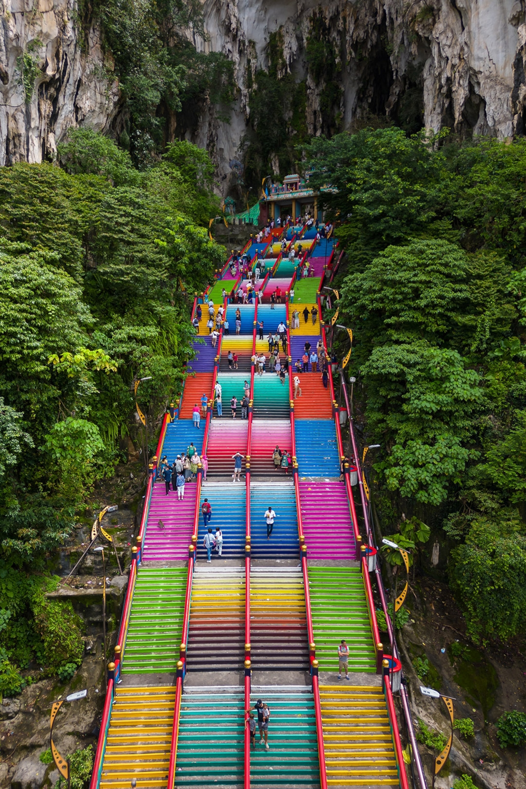 A colourful staircase heading into a mountain rock opening.