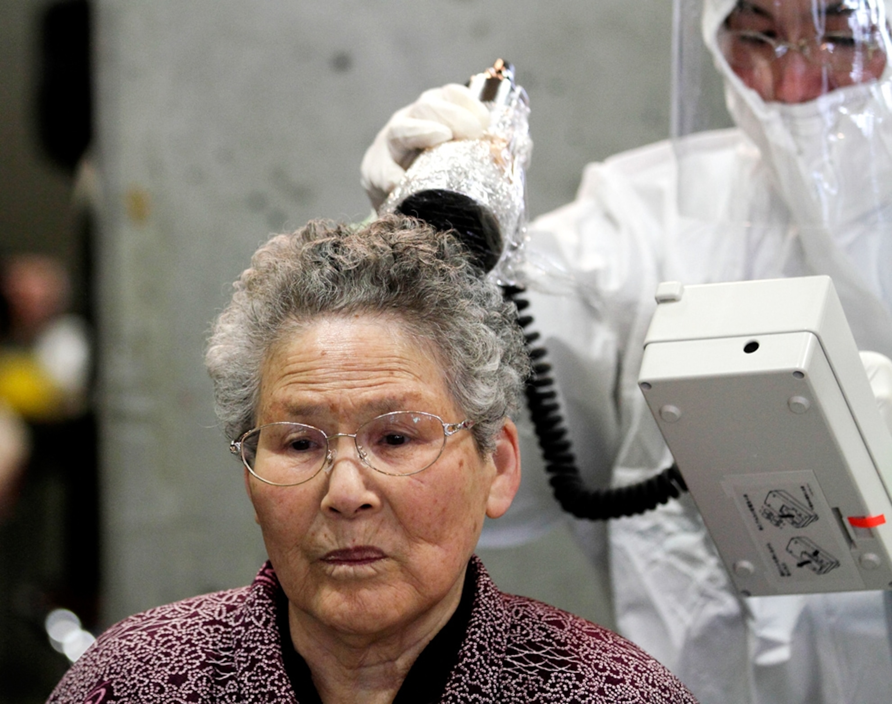A woman is scanned for radiation exposure.