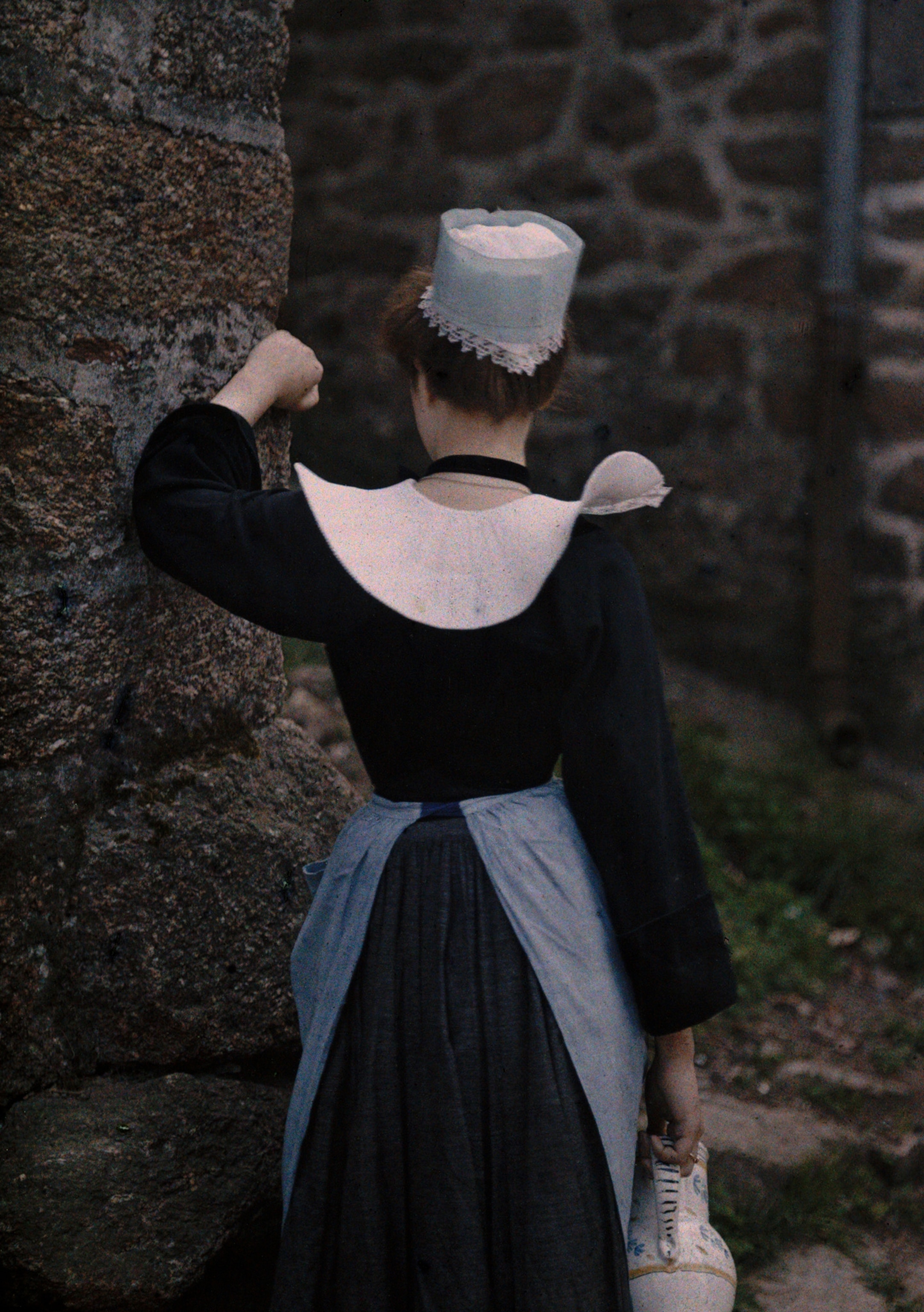 a woman in traditional costume from behind in Pont l'Abbe, Brittany, France
