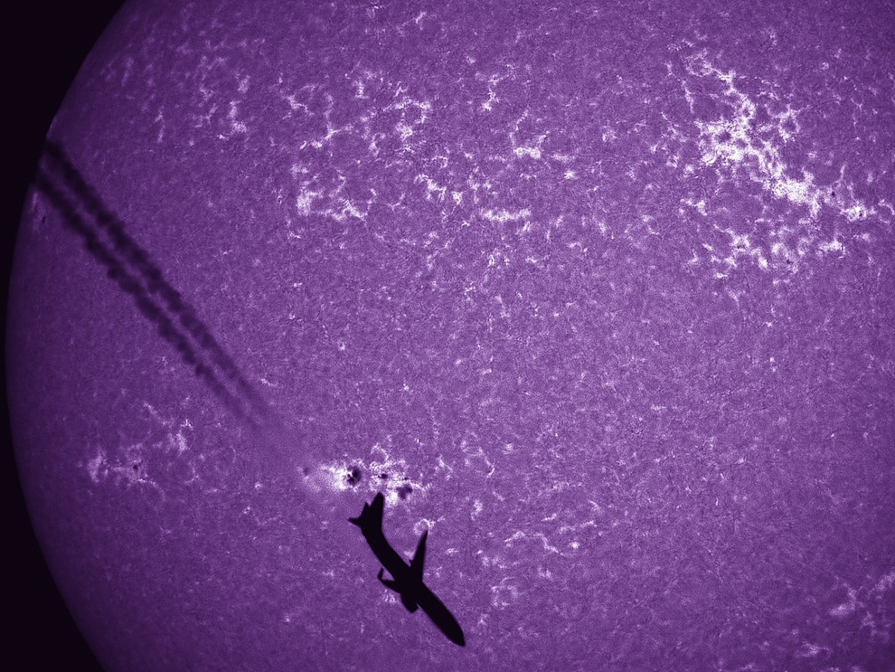 Sun picture: a silhouette of an airplane in front of the sun