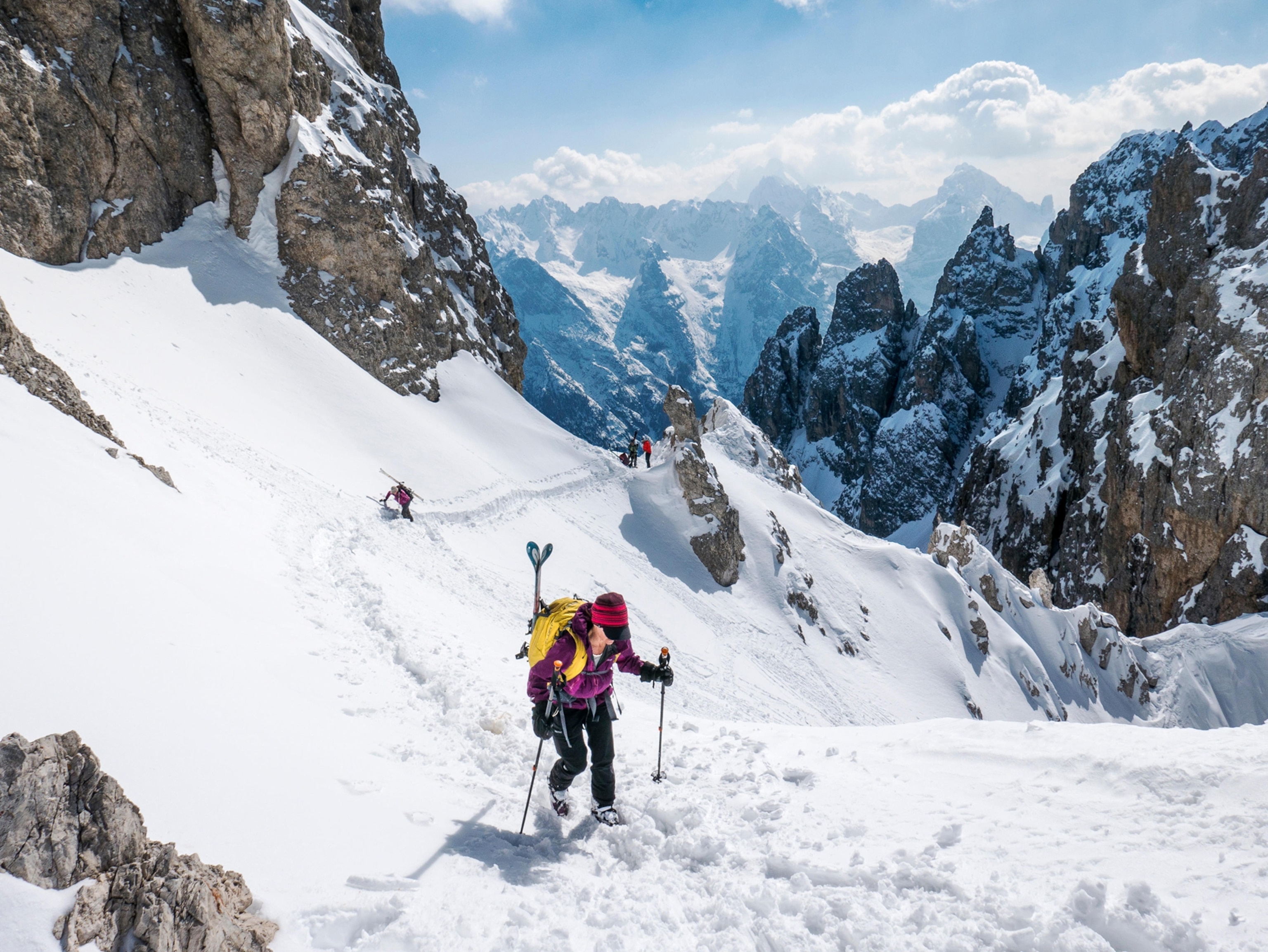 Backcountry skiers traversing steep slope, northeast of Cortina, Dolomite Mountains, Alps, Italy