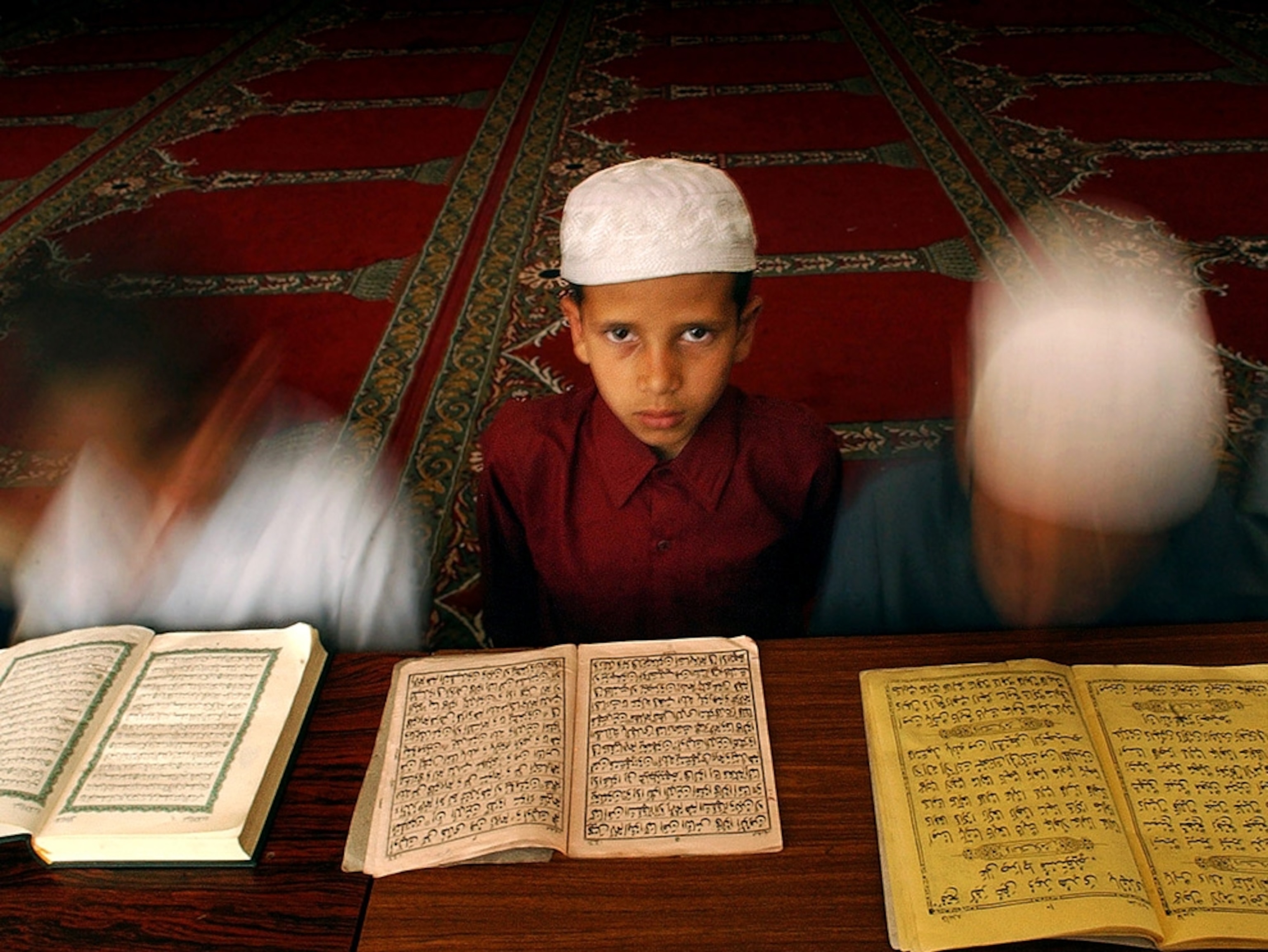 A boy reading in a mosque