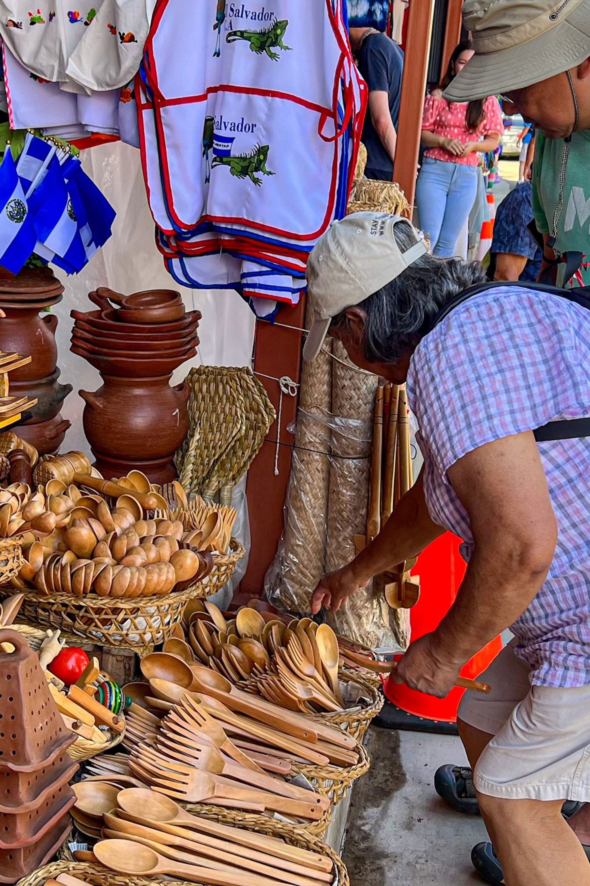 A woman shops for souvenirs at a market stall in Nahuizalco, El Salvador.
