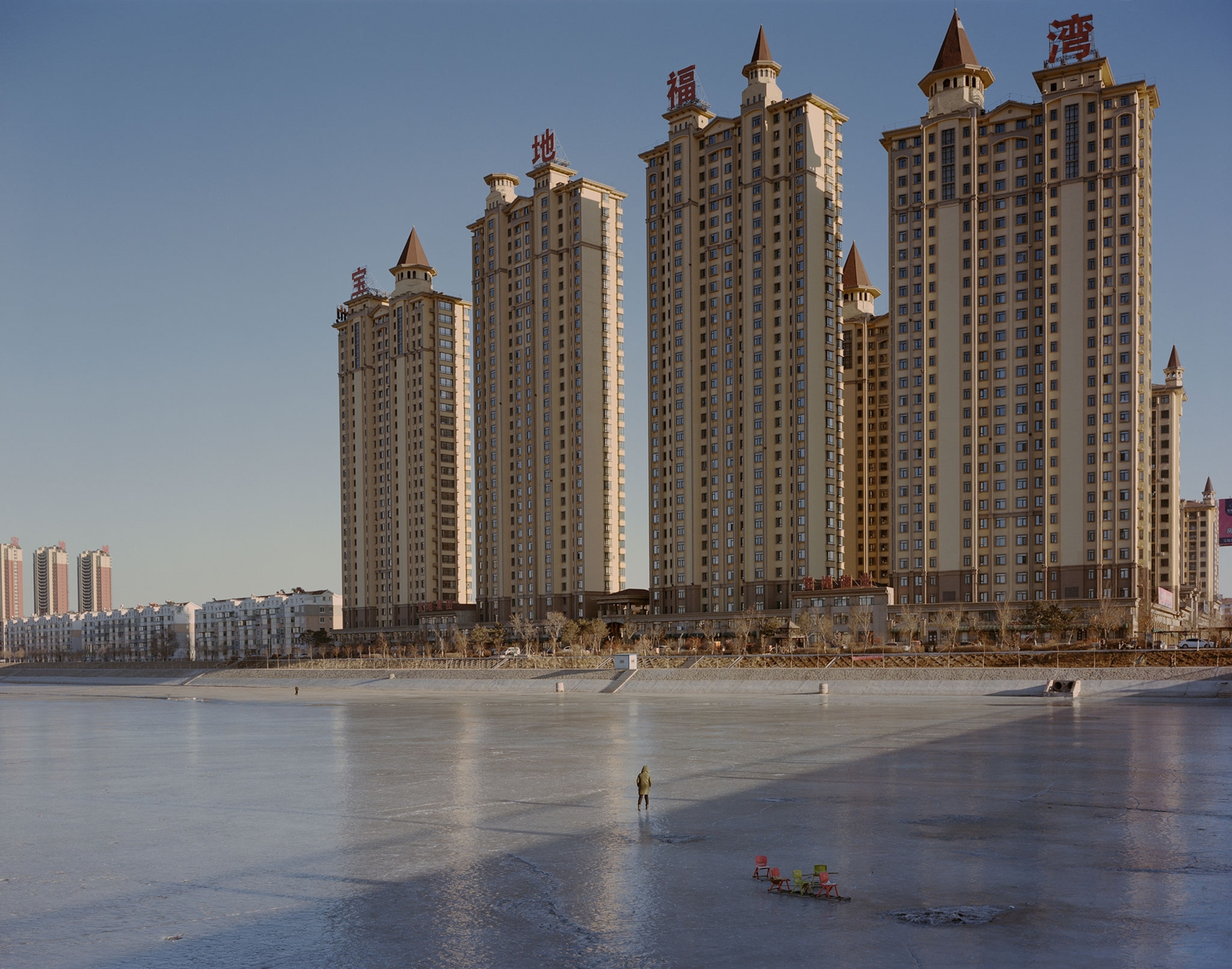 residential buildings beside a frozen river