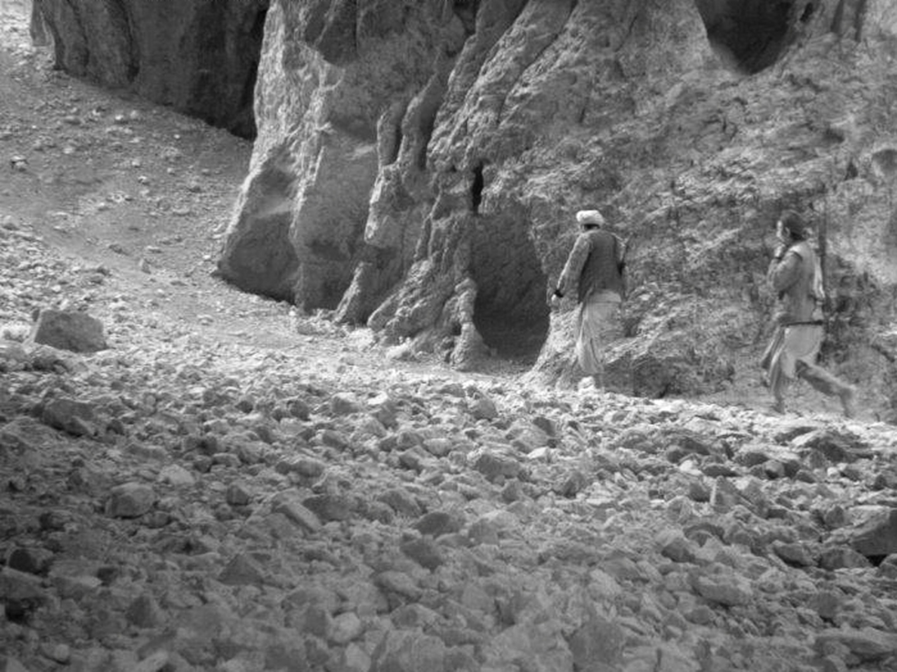 Poachers picture: people with guns pursue an ibex in Afghanistan