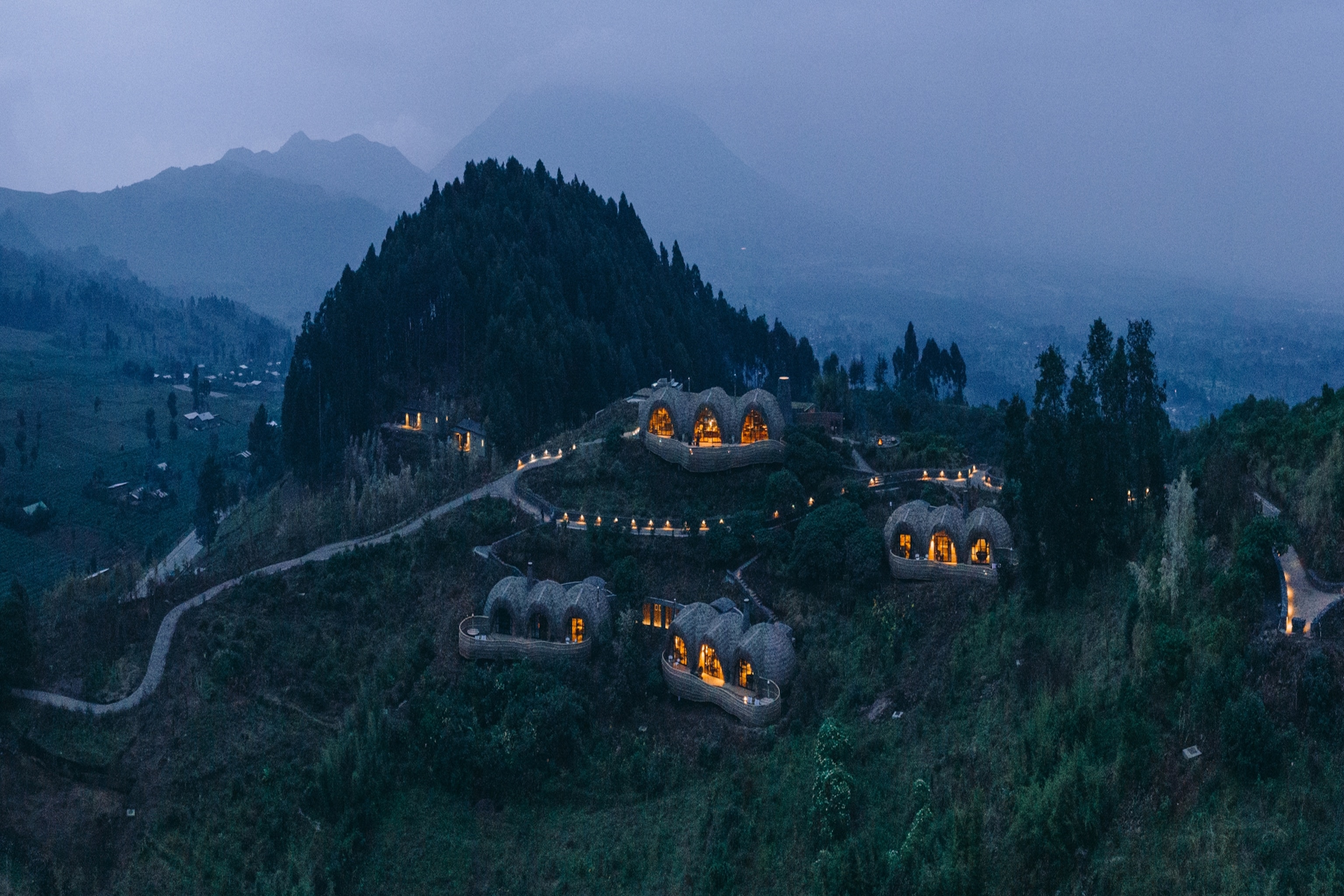 The villas of Wilderness Bisate Reserve are nestled into a hillside in Rwanda's Volcanoes National Park.