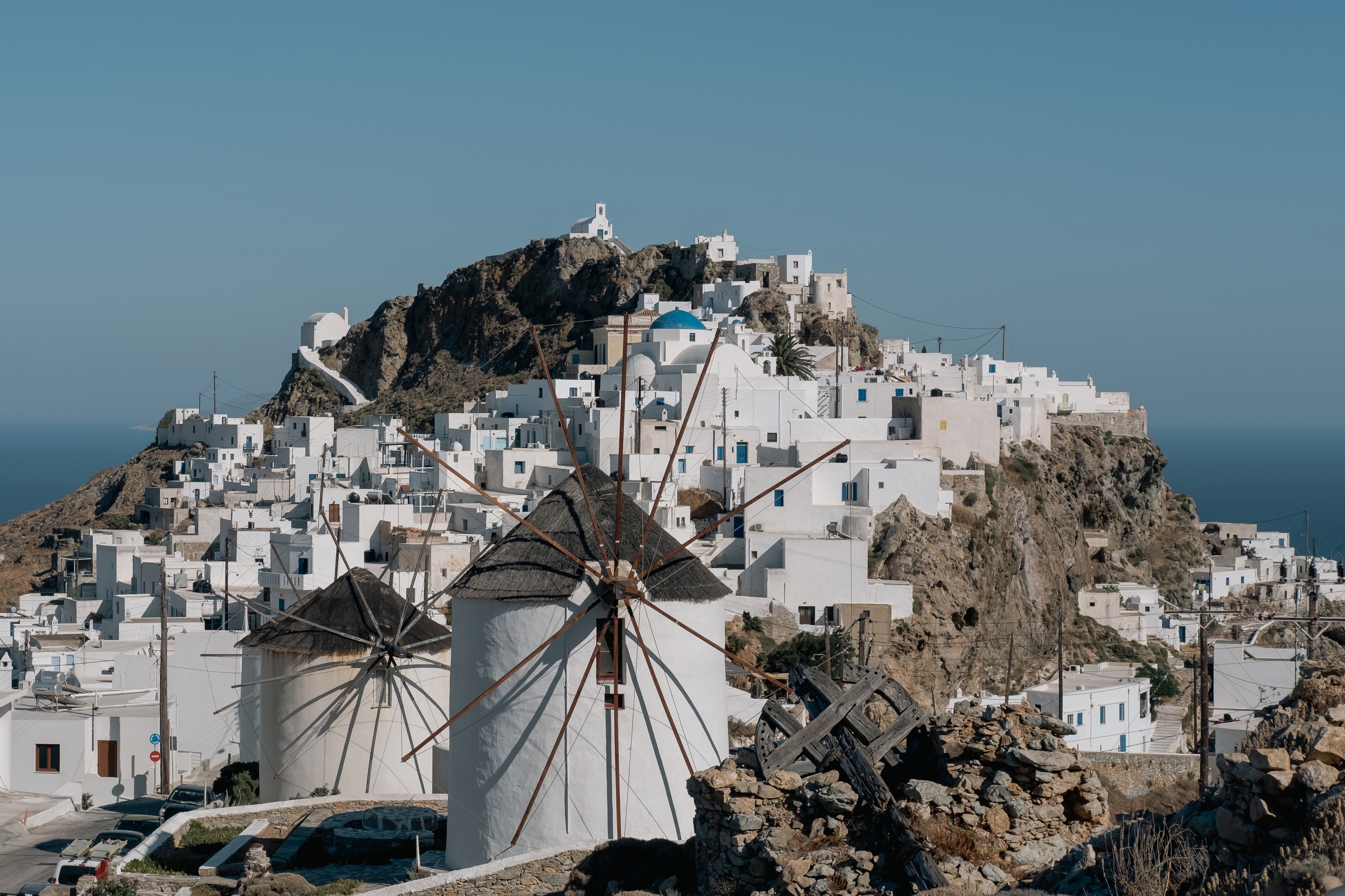White windmills and houses on island