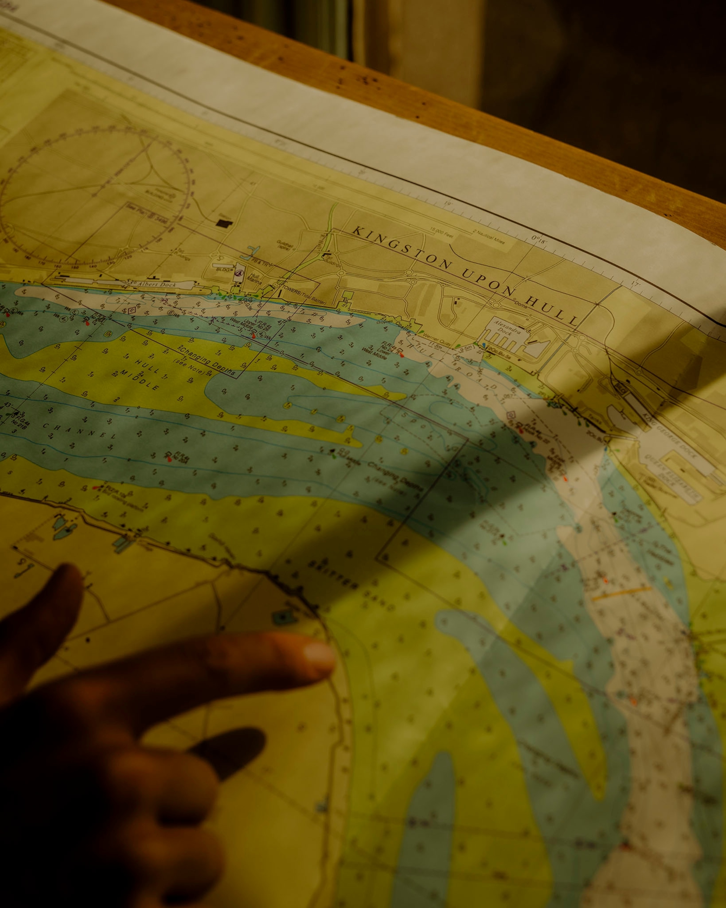 Hull, United Kingdom — July 2025: Scenes from Hull’s maritime heritage and community, including a sea chart of Kingston upon Hull and the Humber, photographed inside B. Cooke & Son Ltd, a historic nautical instrument shop.