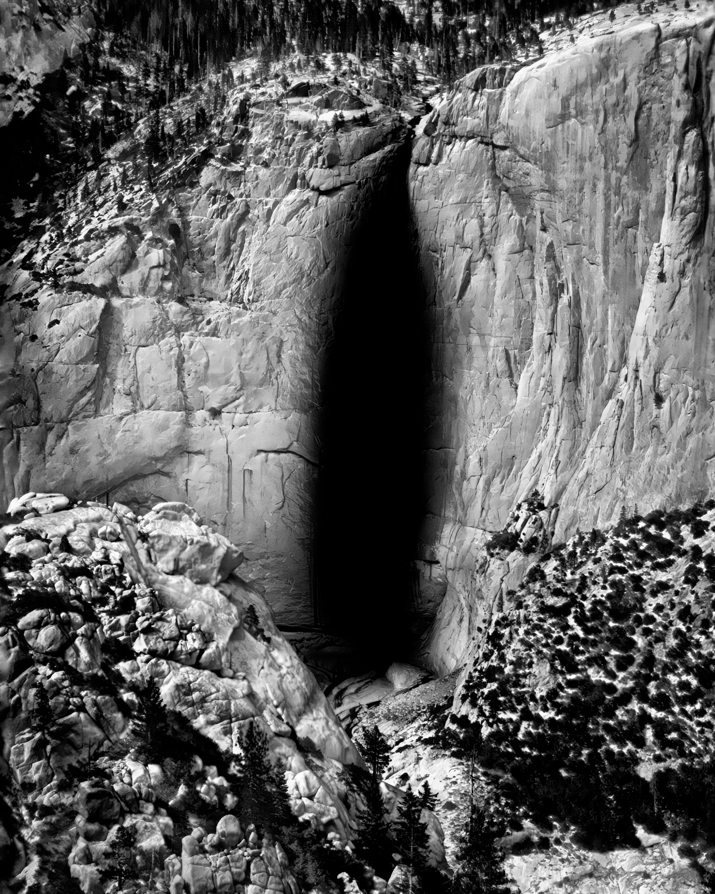 A thermal black and white photo of the frigid water of Yosemite Falls, with the objects that are the hottest appear brightest, while those that are coldest appear darkest.