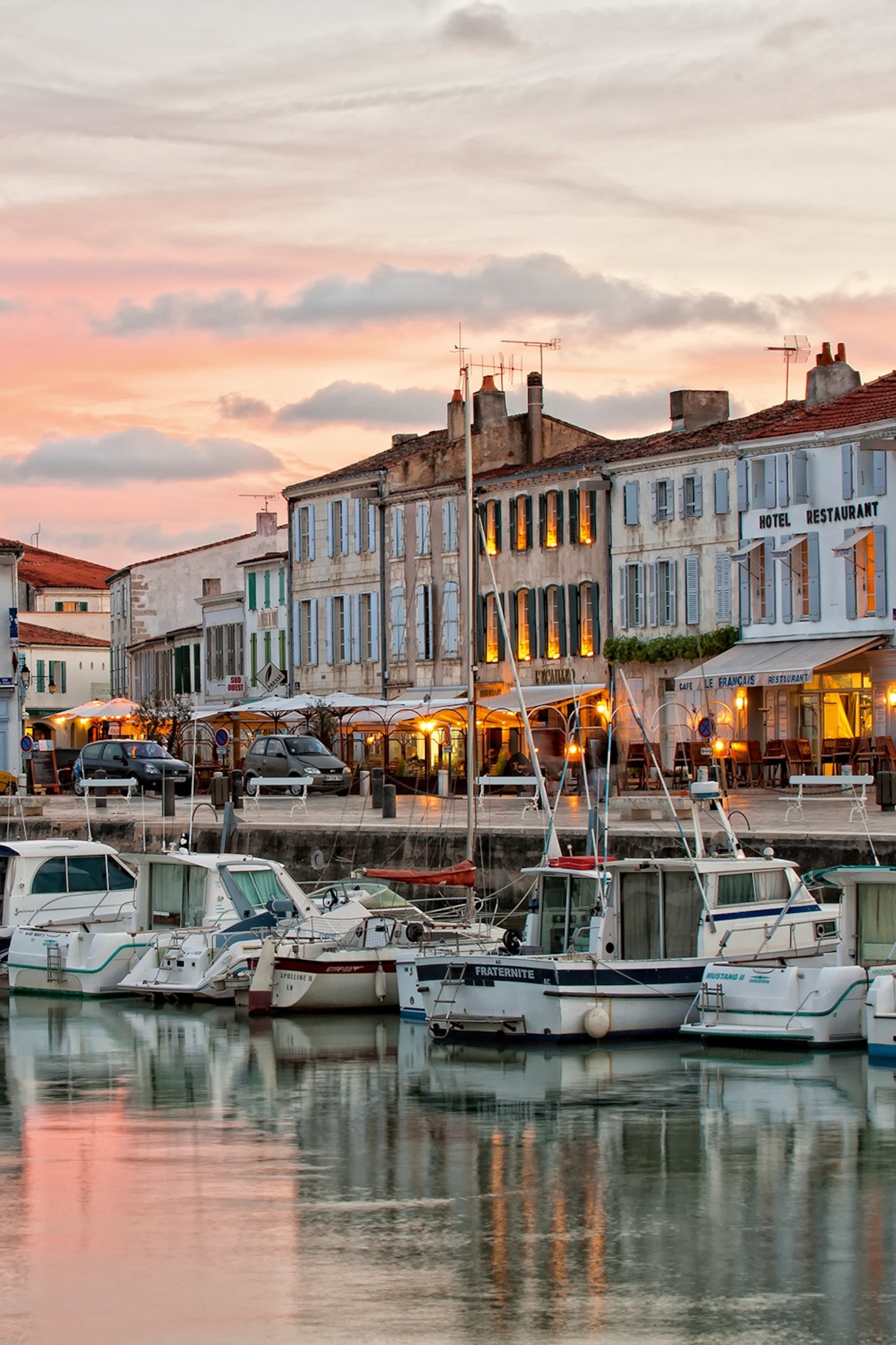 A romantic harbour on a French island at sunset.
