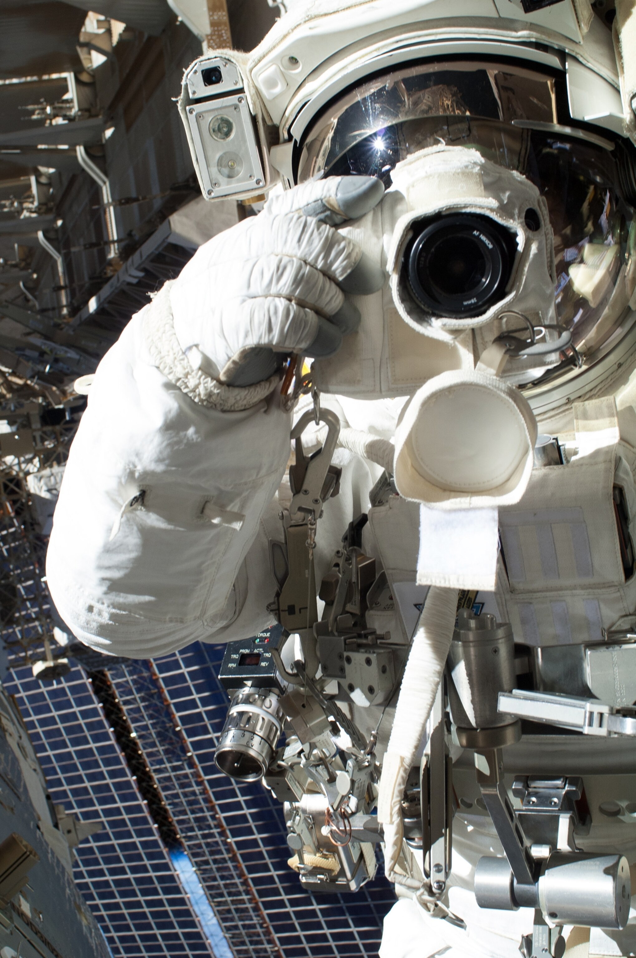 American astronaut Chris Cassidy posing with his digital camera during a spacewalk