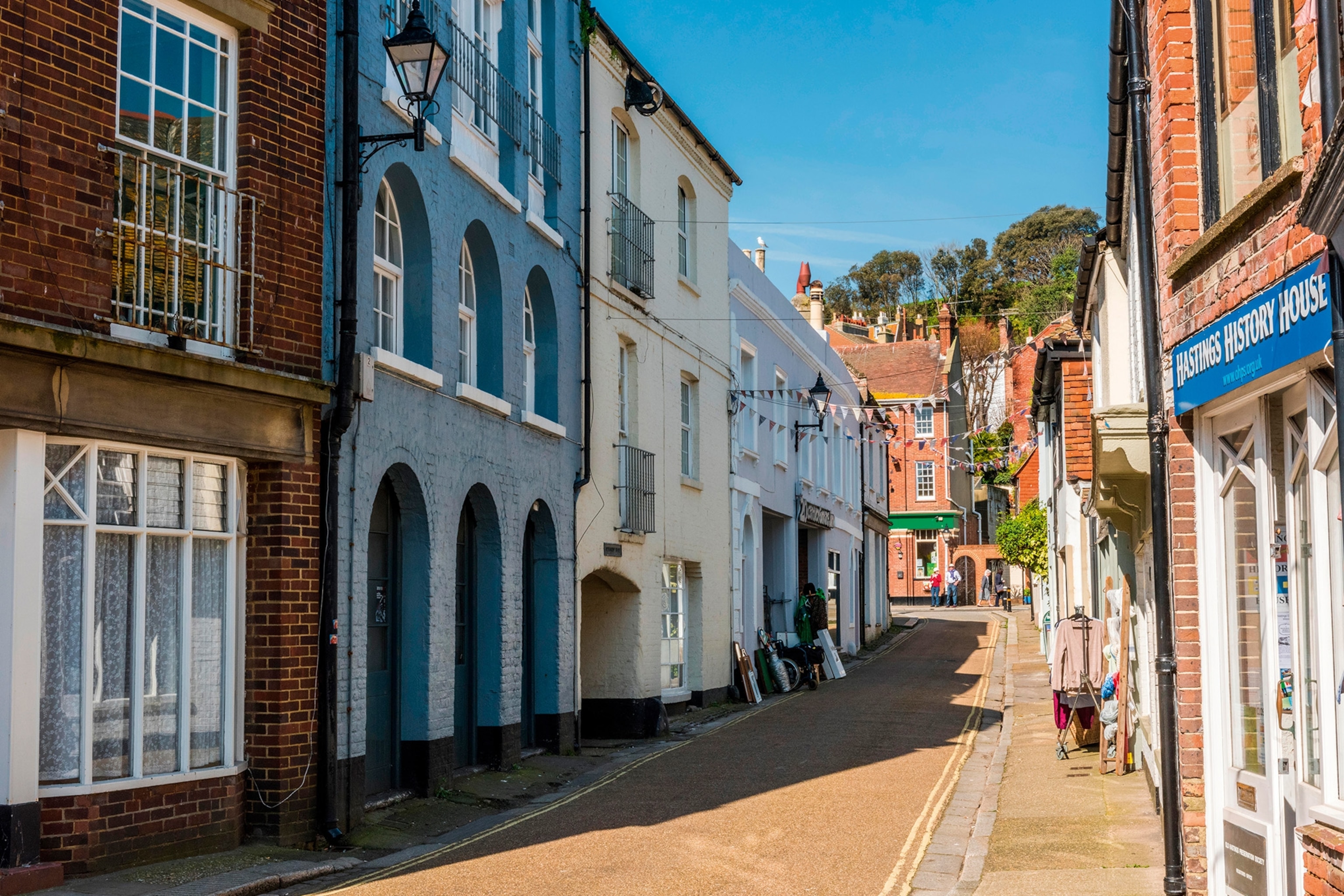 Multicoloured buildings and decorative flags on Courthouse Street in Hastings Old Town