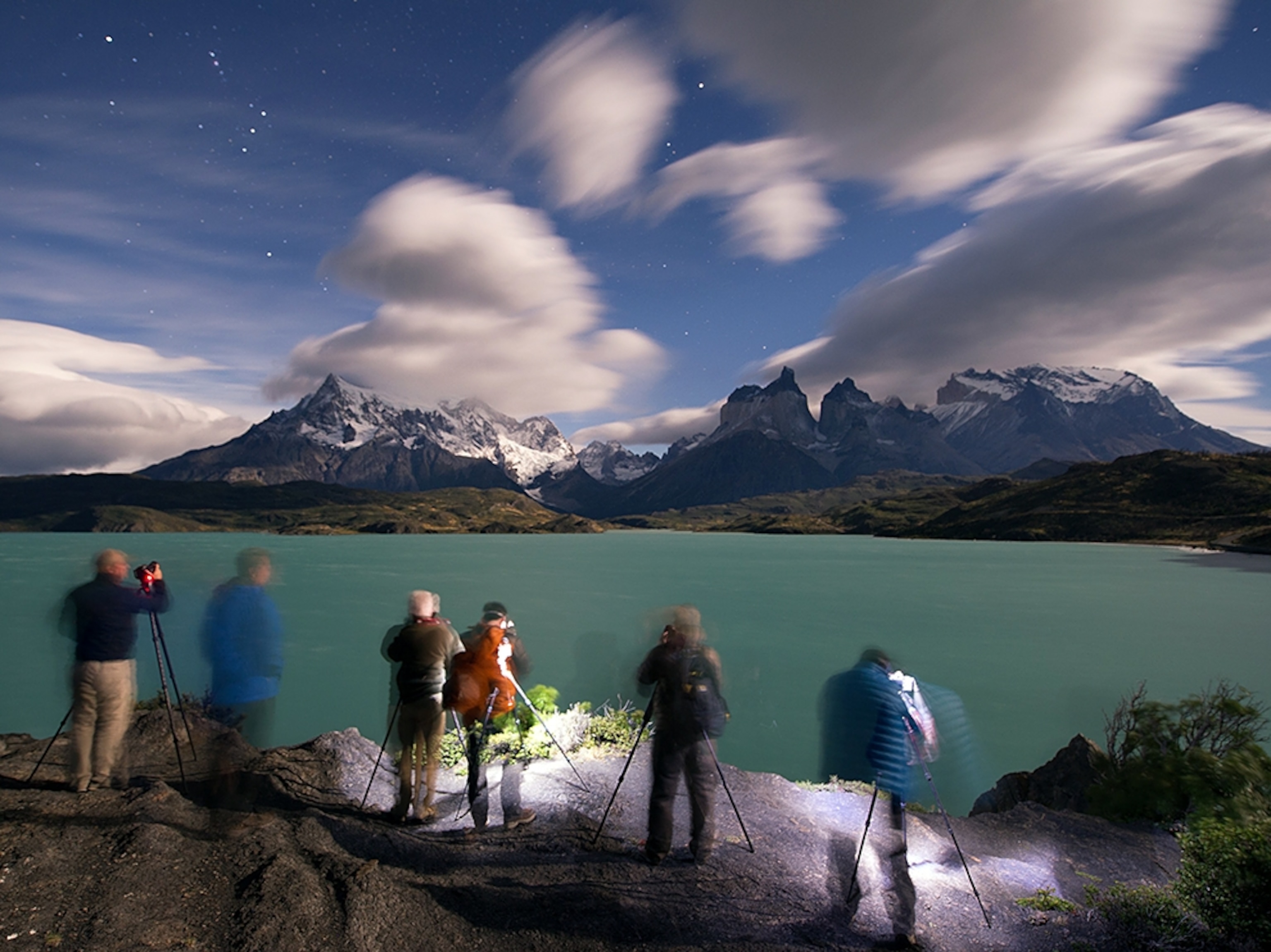 photographers lined up to photograph stars above Lake Pehoe, Chile