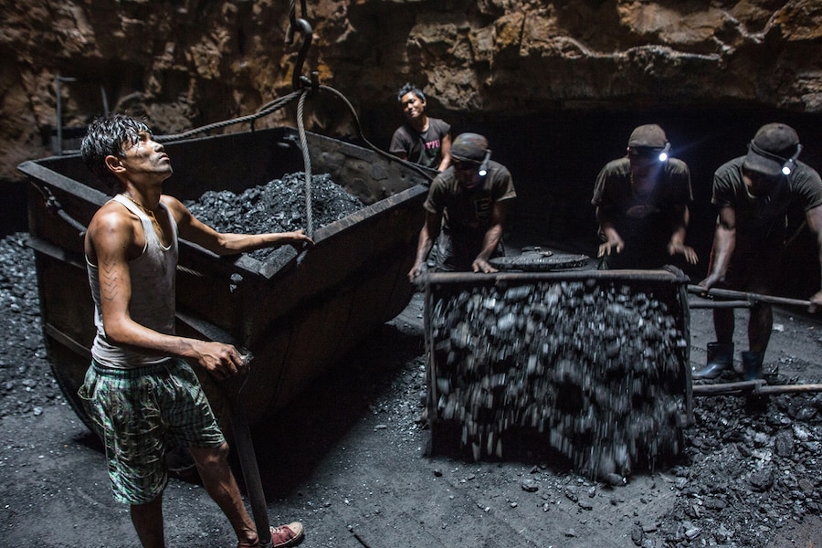 Miners loading coal tubs underground