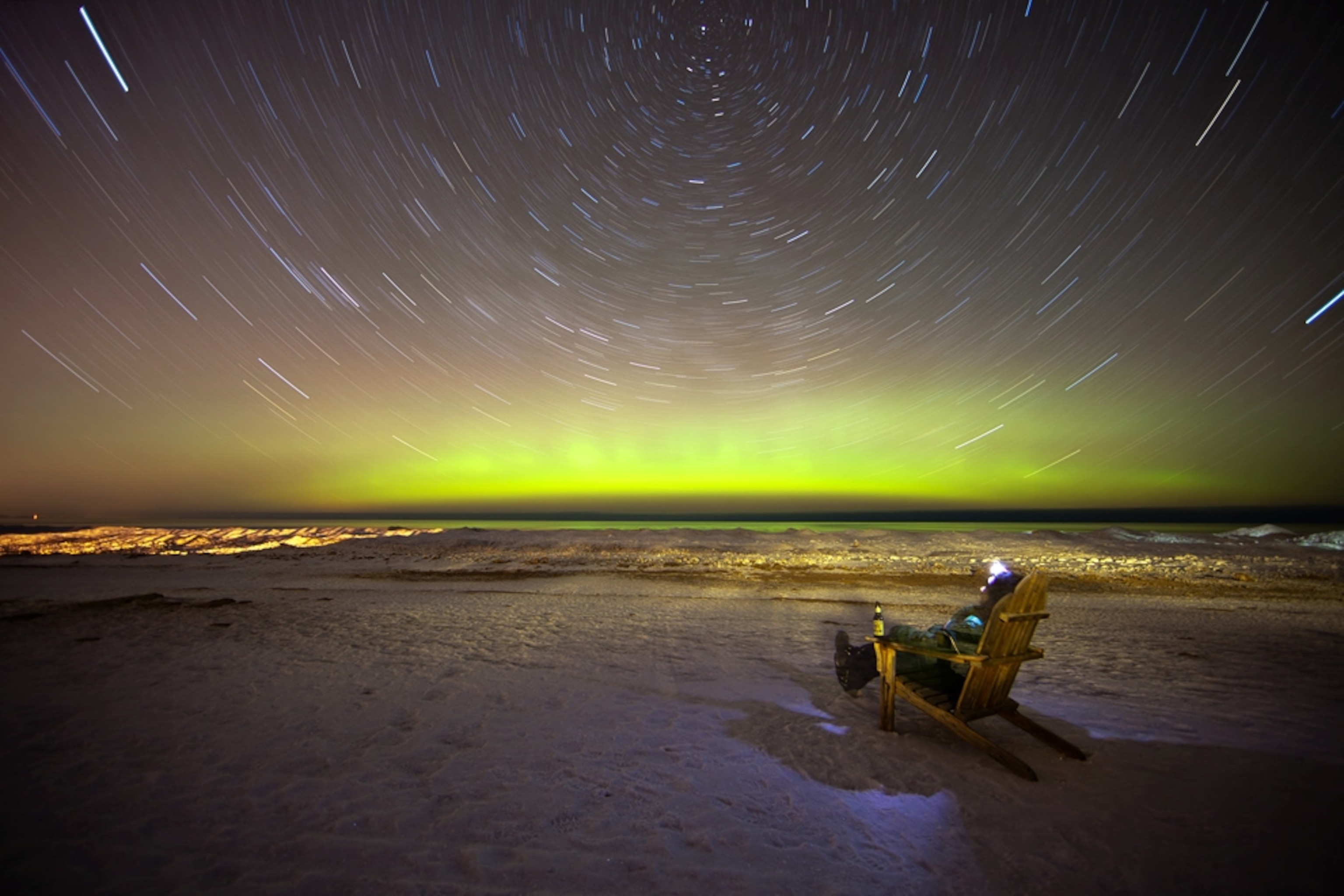 Aurora picture: a person watching auroras from a lawn chair