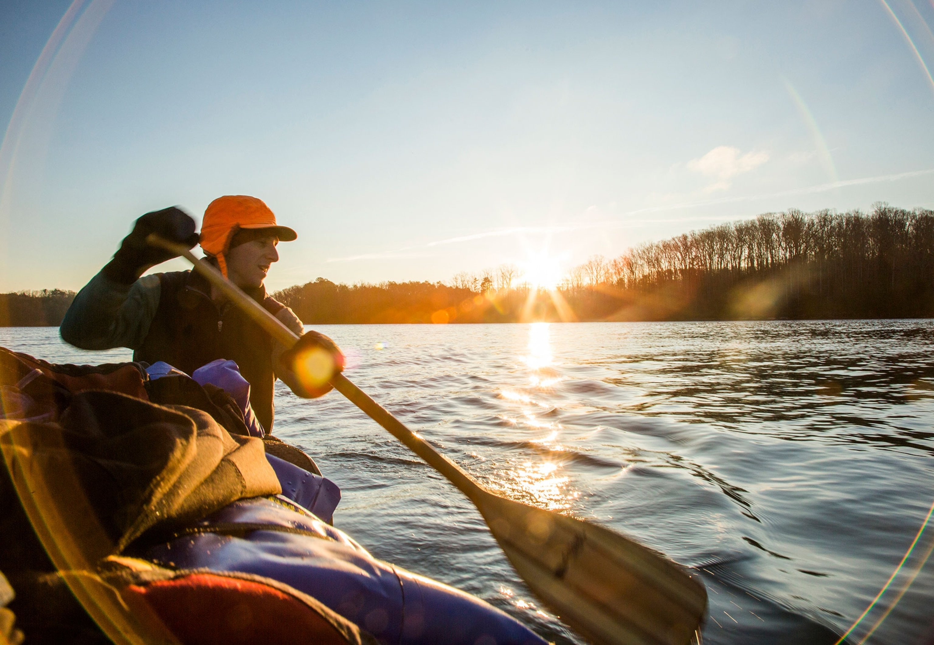 a man canoeing down the calm Chattahoochee River in North Georgia