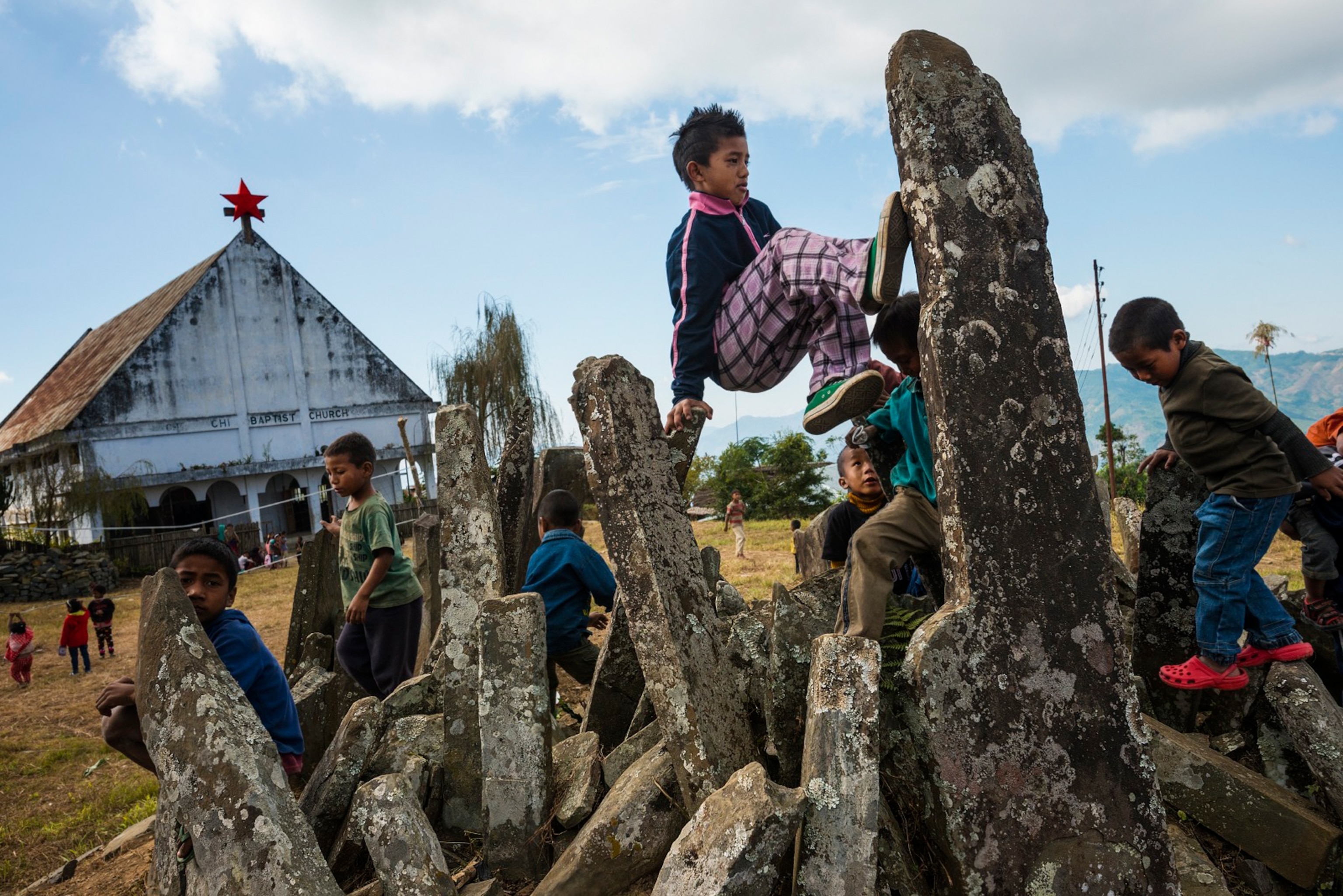 naga kids playing on rocks that represent skulls