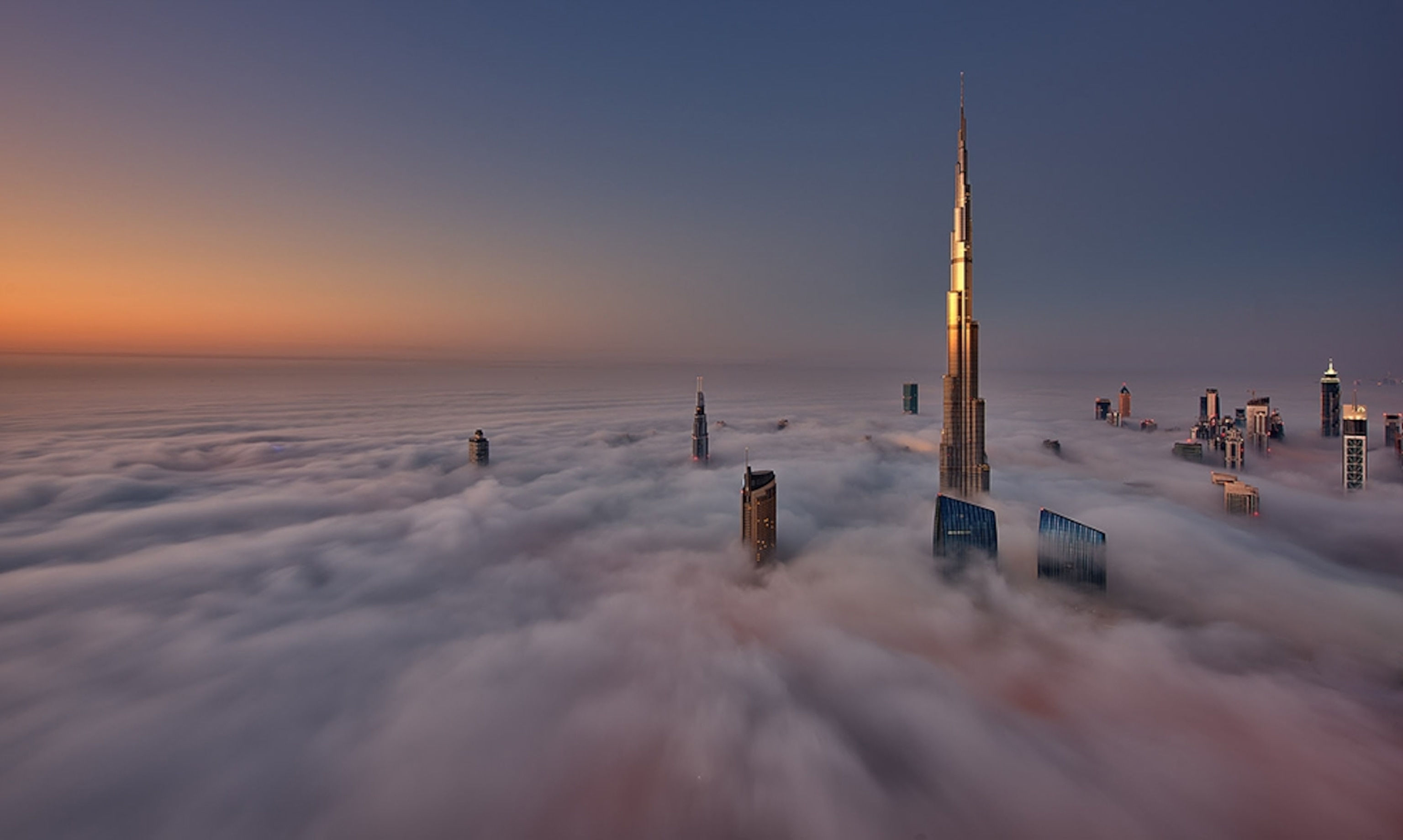 the Burj Khalifa tower above fog, Dubai