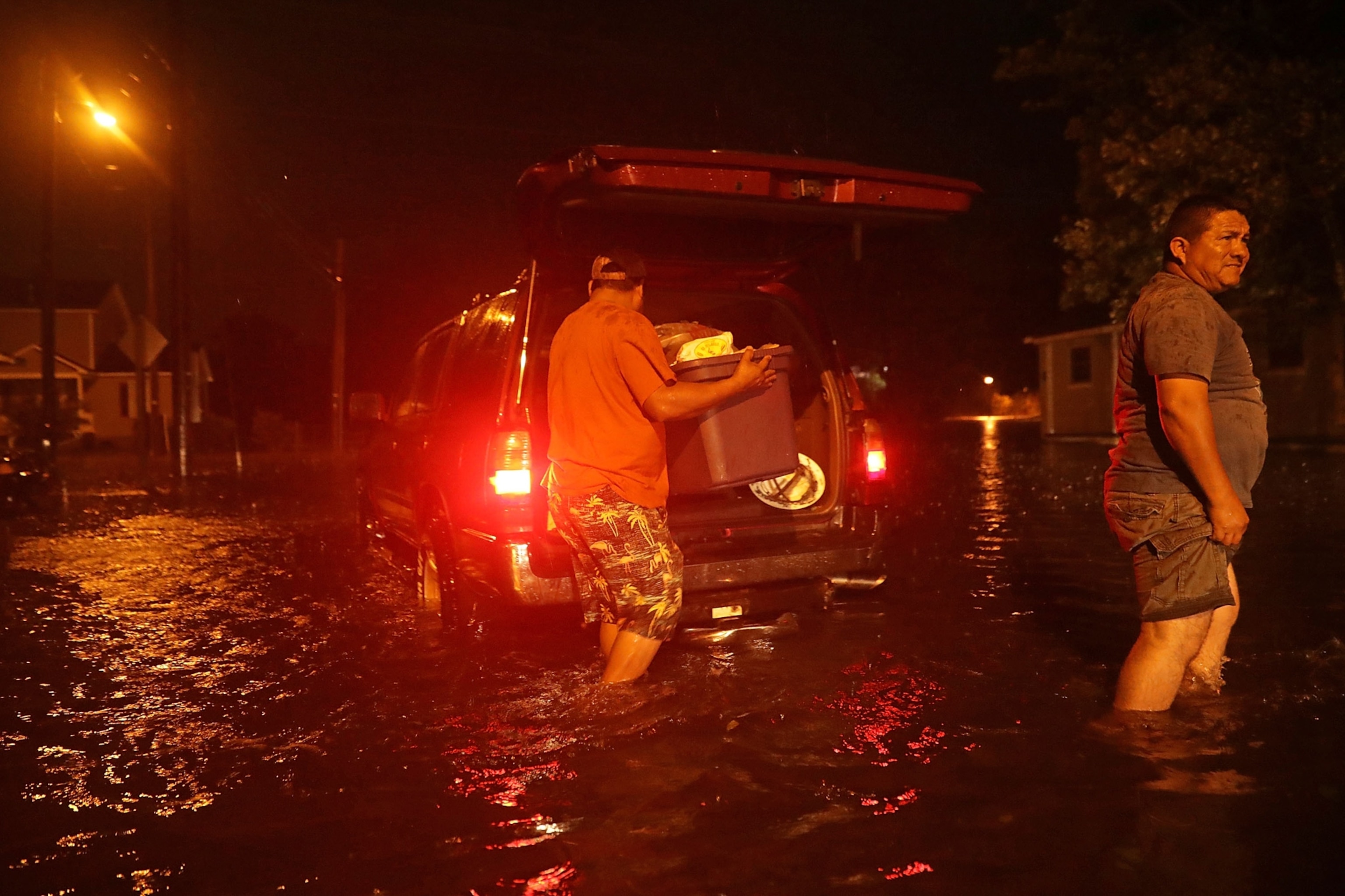 men packing their belongings after evacuating before Hurricane Florence hits