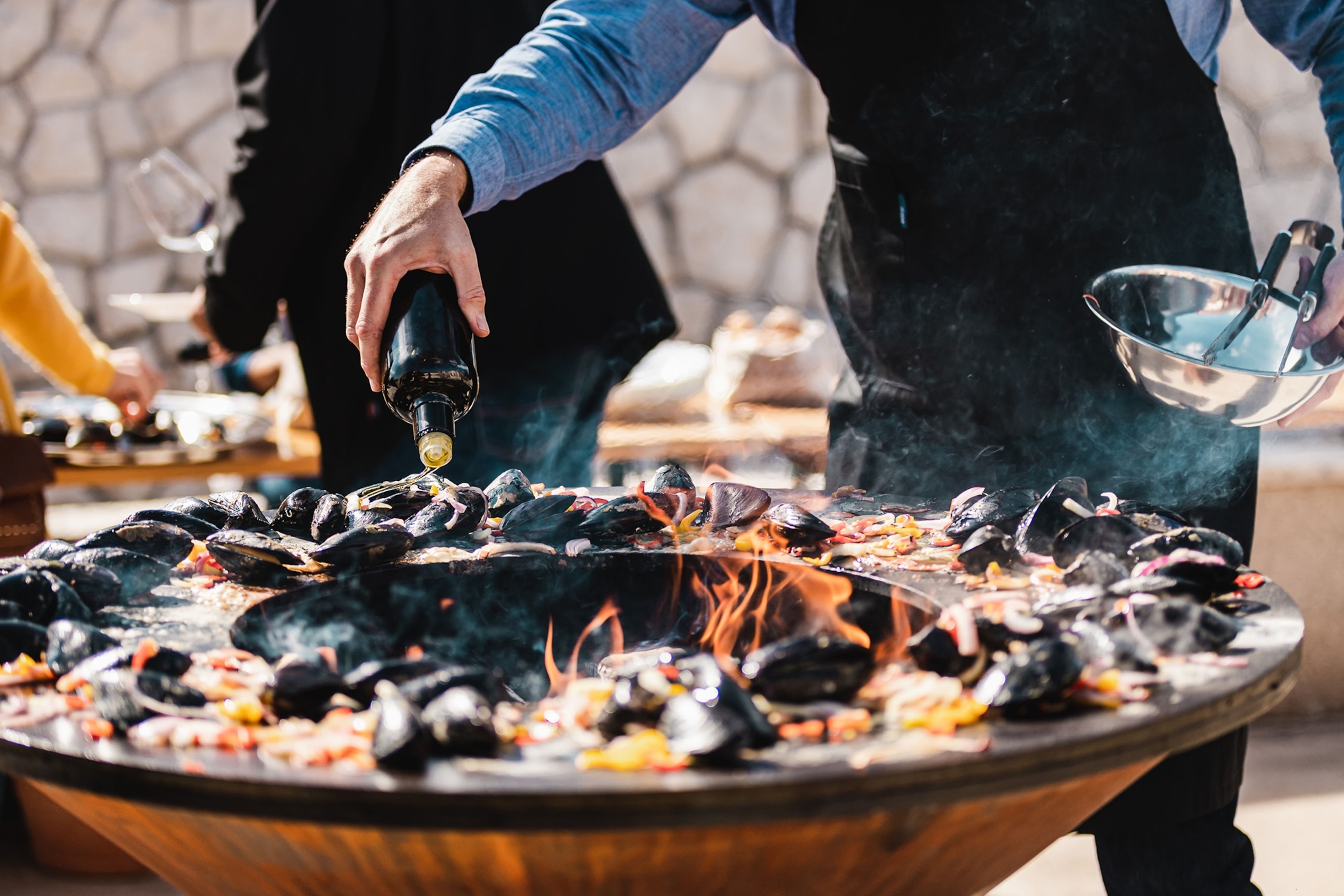 Mussles being cooked in a large pan