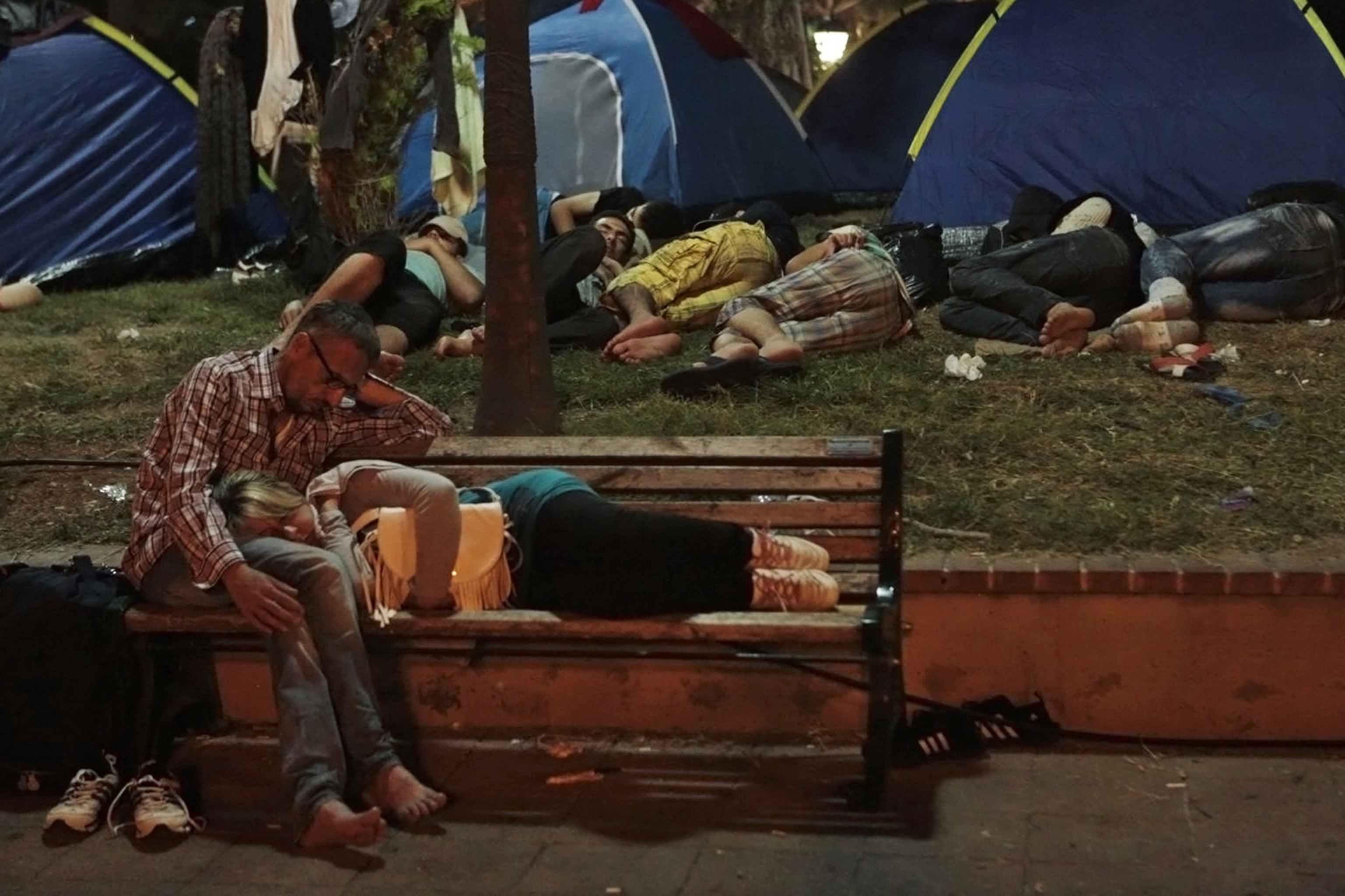 Syrian couple resting on a bench in Mitilinit Sep. 5, 2015