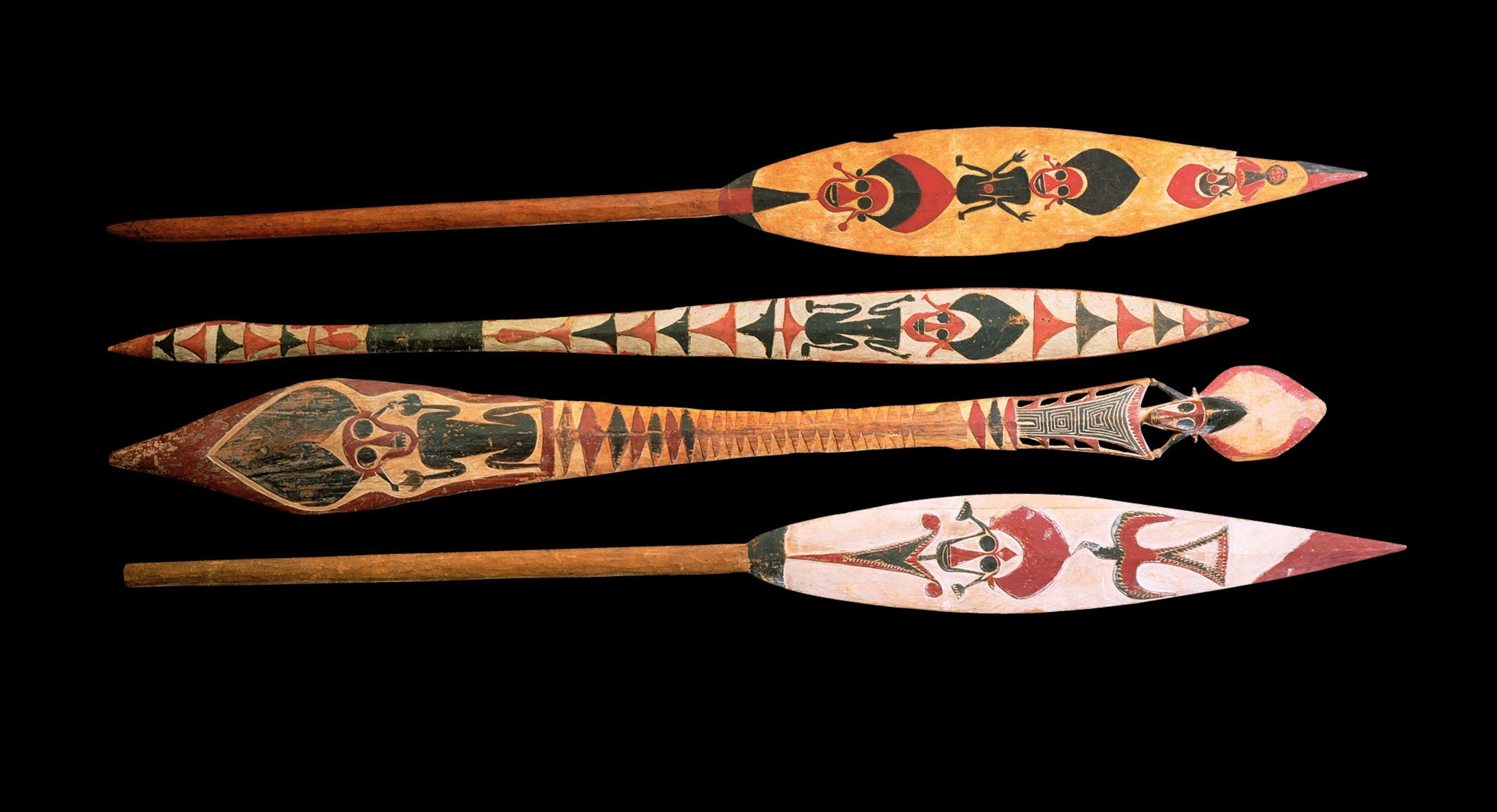 A row of 4 decorated buka paddles
