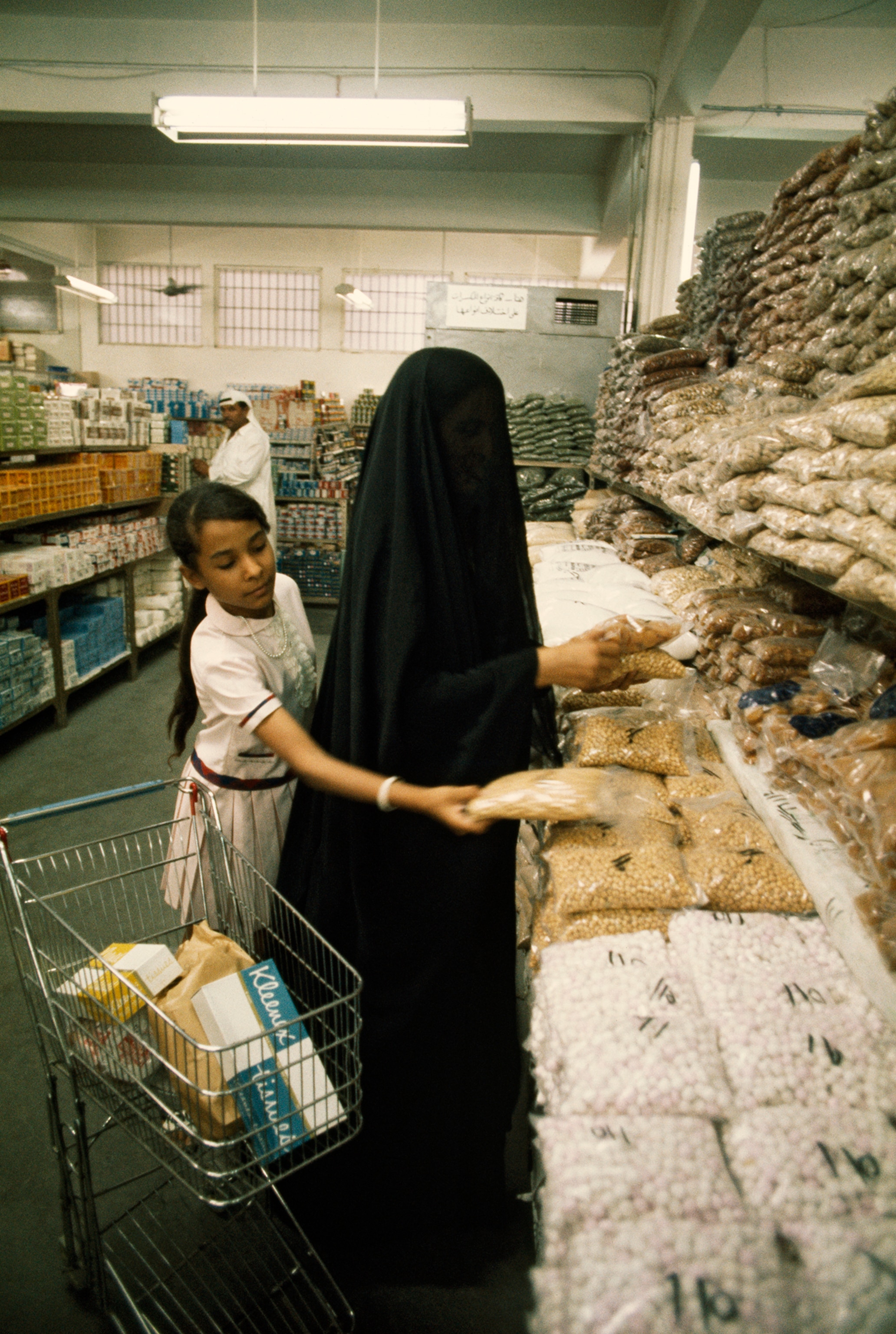 Mother and daughter shop in a grocery store in Kuwait