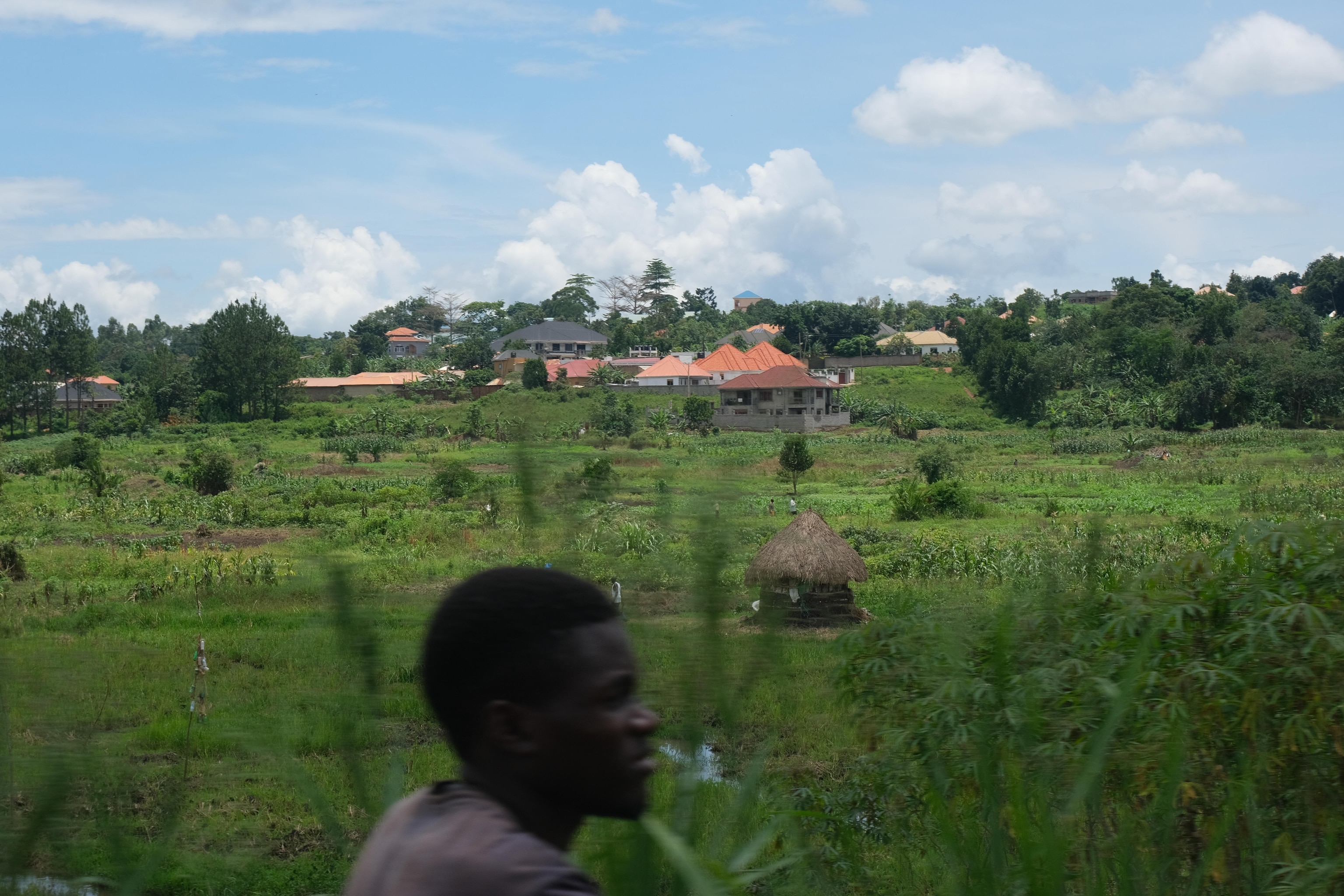 A man stands in front of a plantation and behind him a new neighborhood is being built outside the flood zone on April 8, 2025. Photographed by student Bonny Arocha. The Uganda Photo Camp, held in Bamunanika from April 5-9, 2025, is part of a larger initiative exploring the interconnected themes of access, equality, and stewardship of freshwater resources across East Africa. During this transformative program, students collaborated with National Geographic explorers and Photo Camp staff, honing their photography and writing skills while building meaningful connections within their communities and peers.