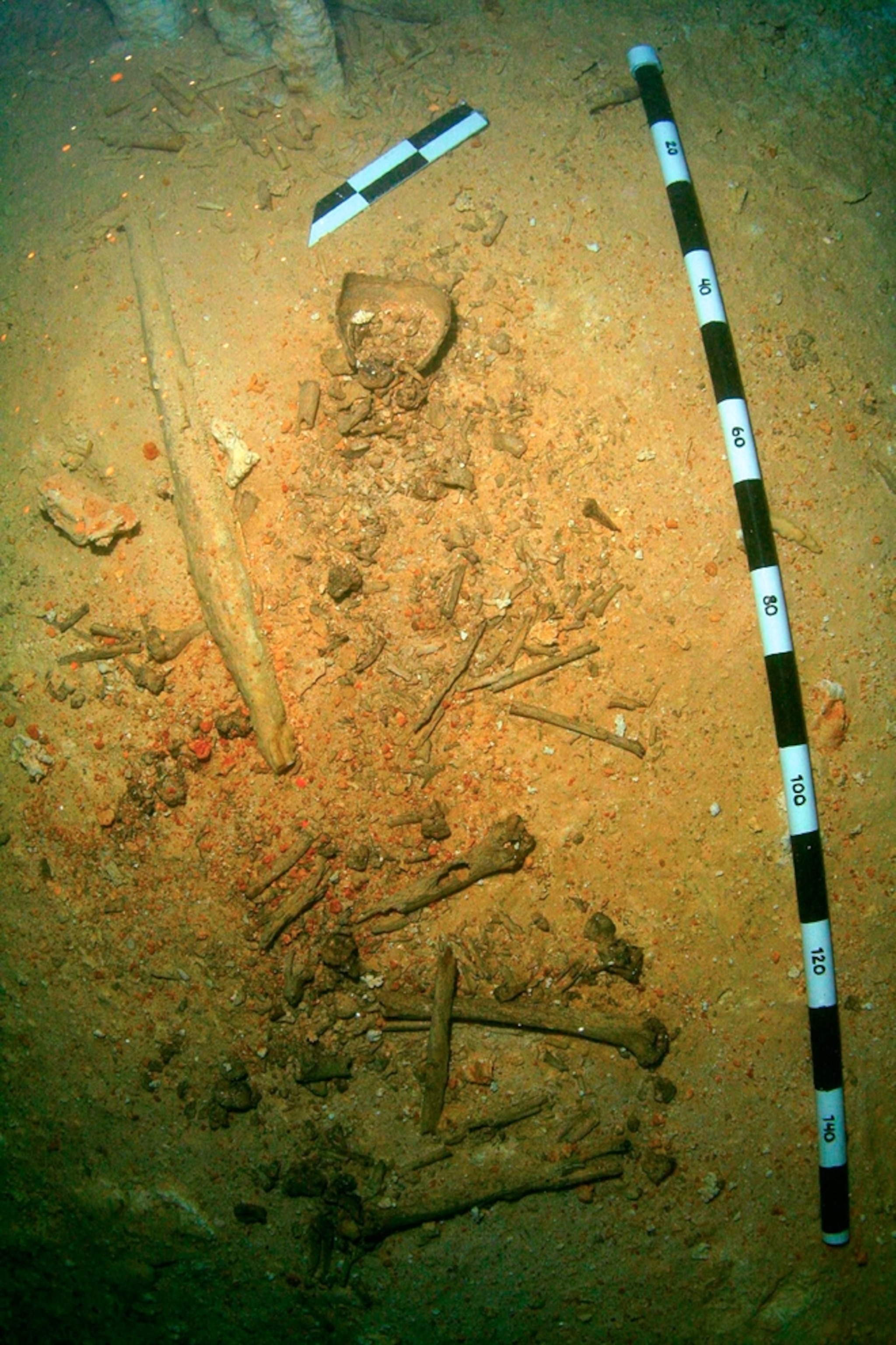 The bones of the Young Man of Chan Hol on a cave floor.
