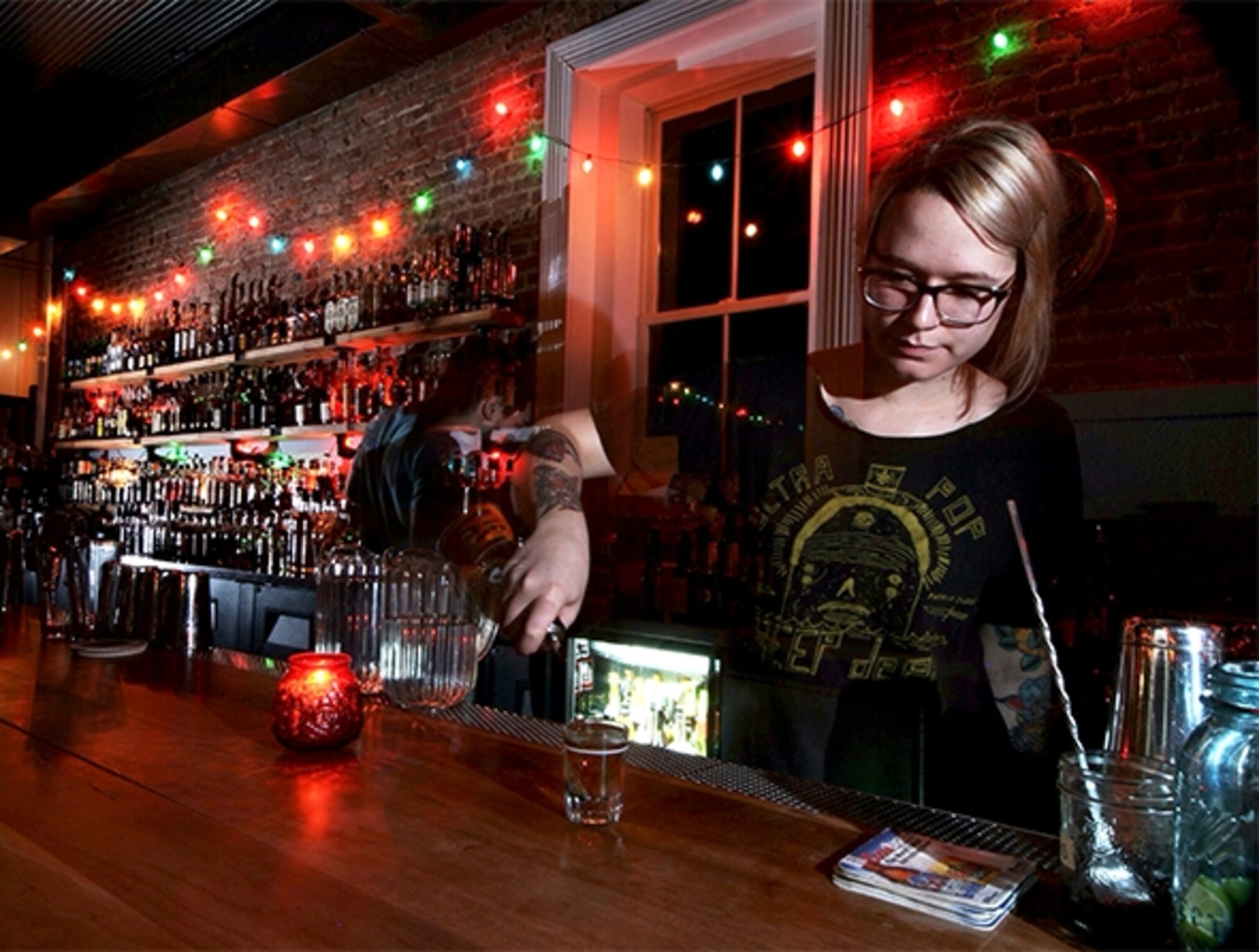 A bartender pours a glass of whiskey at Silver Dollar (Photograph by Thomas Wavid Johns)