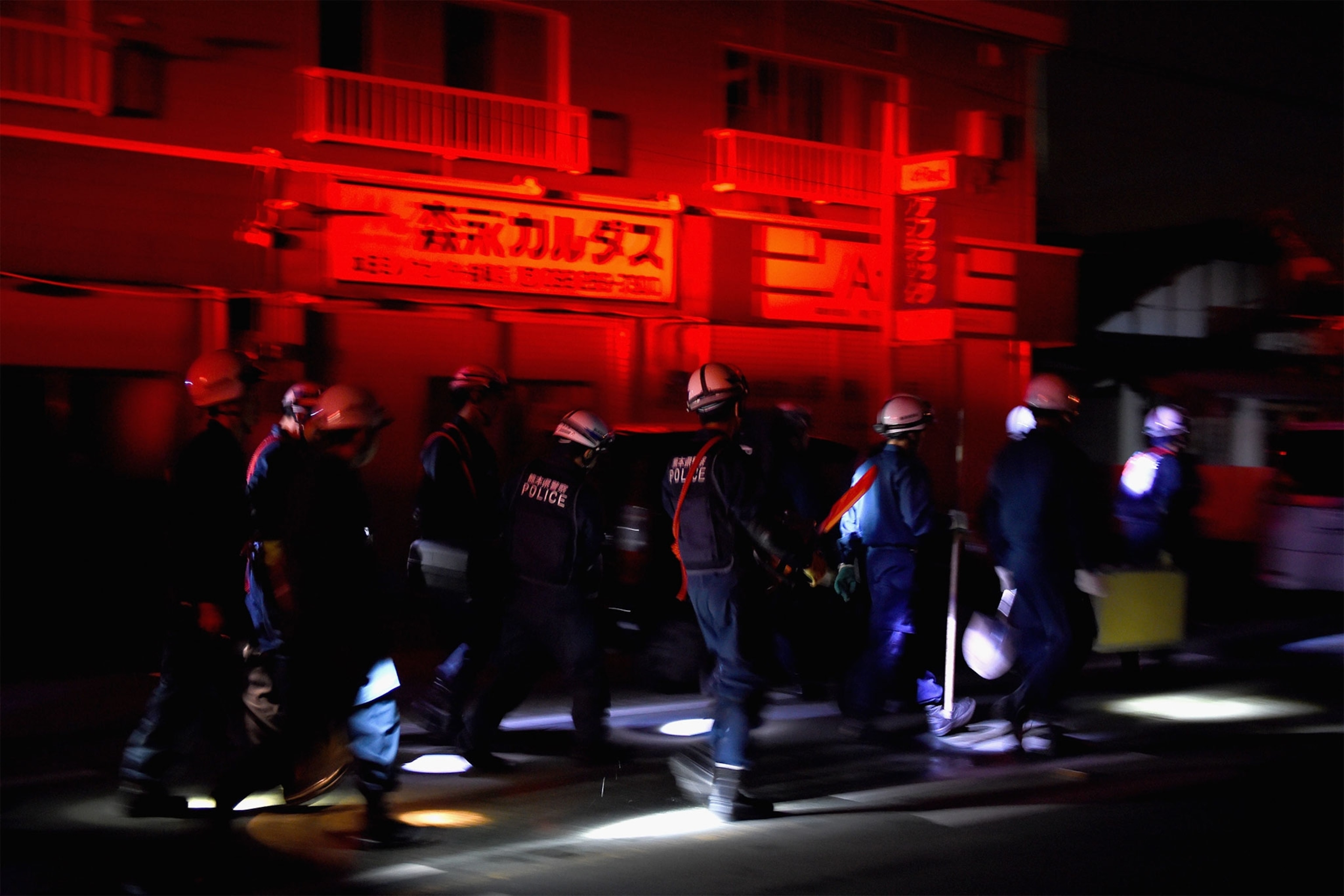 police at night after an earthquake in Japan