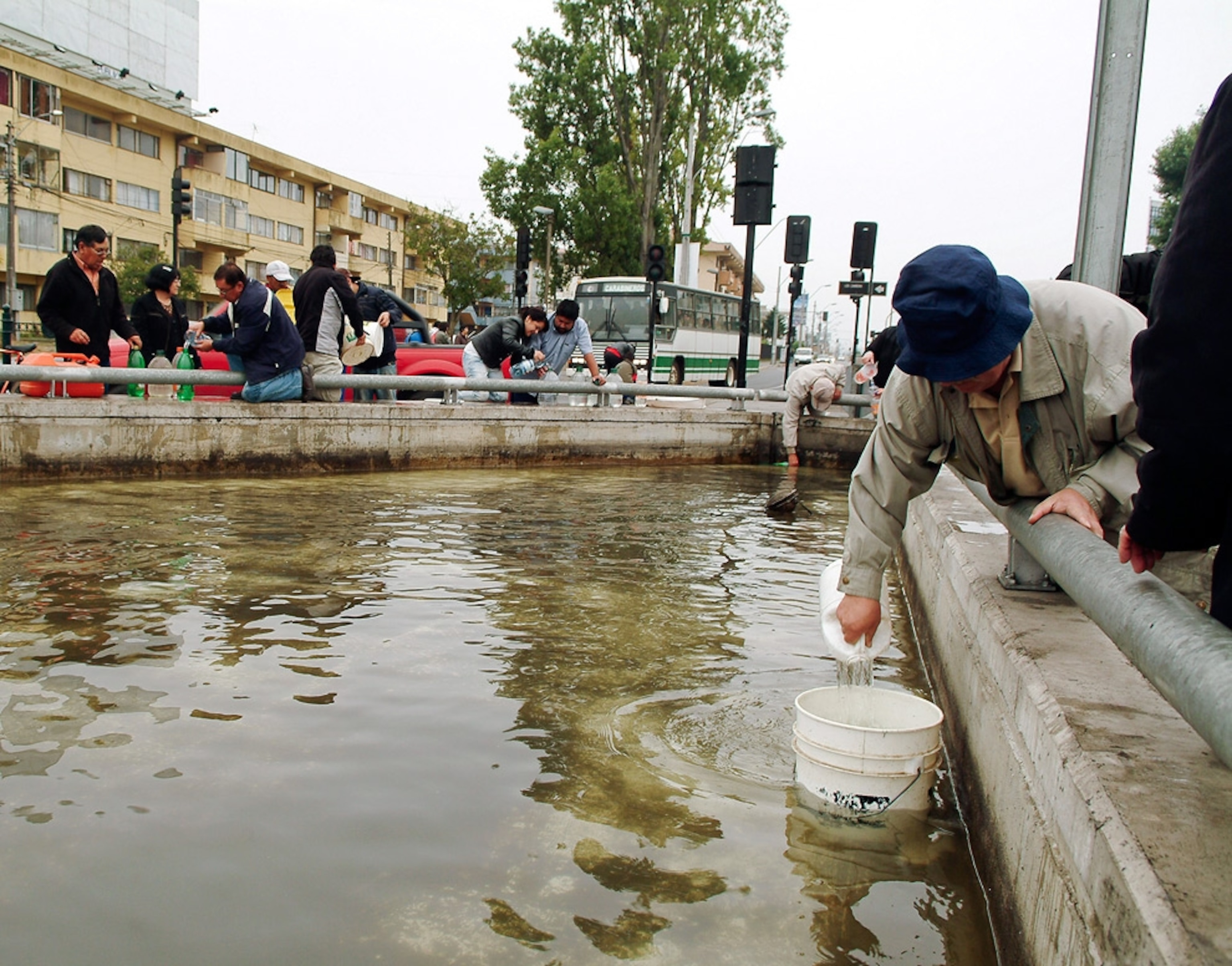 A picture shows Chile earthquake survivors gathering water after the Chile earthquake