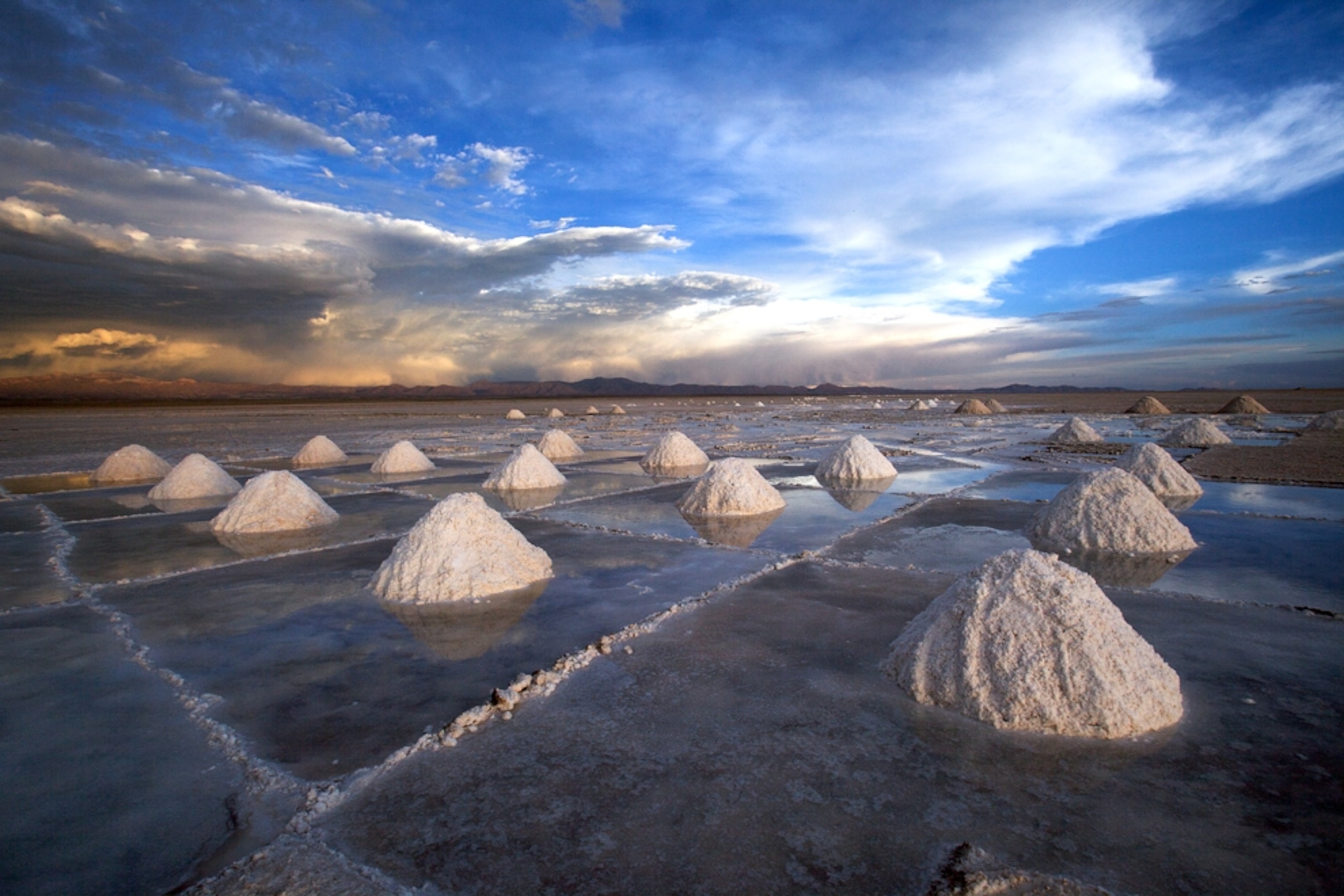 Extracted salt sits in piles at the Uyuni salt flats in Uyuni, Bolivia
