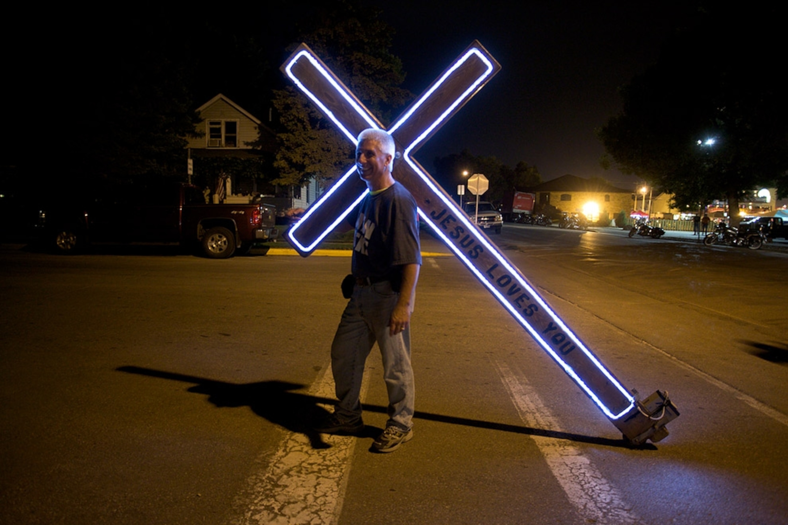 Man carrying lighted cross